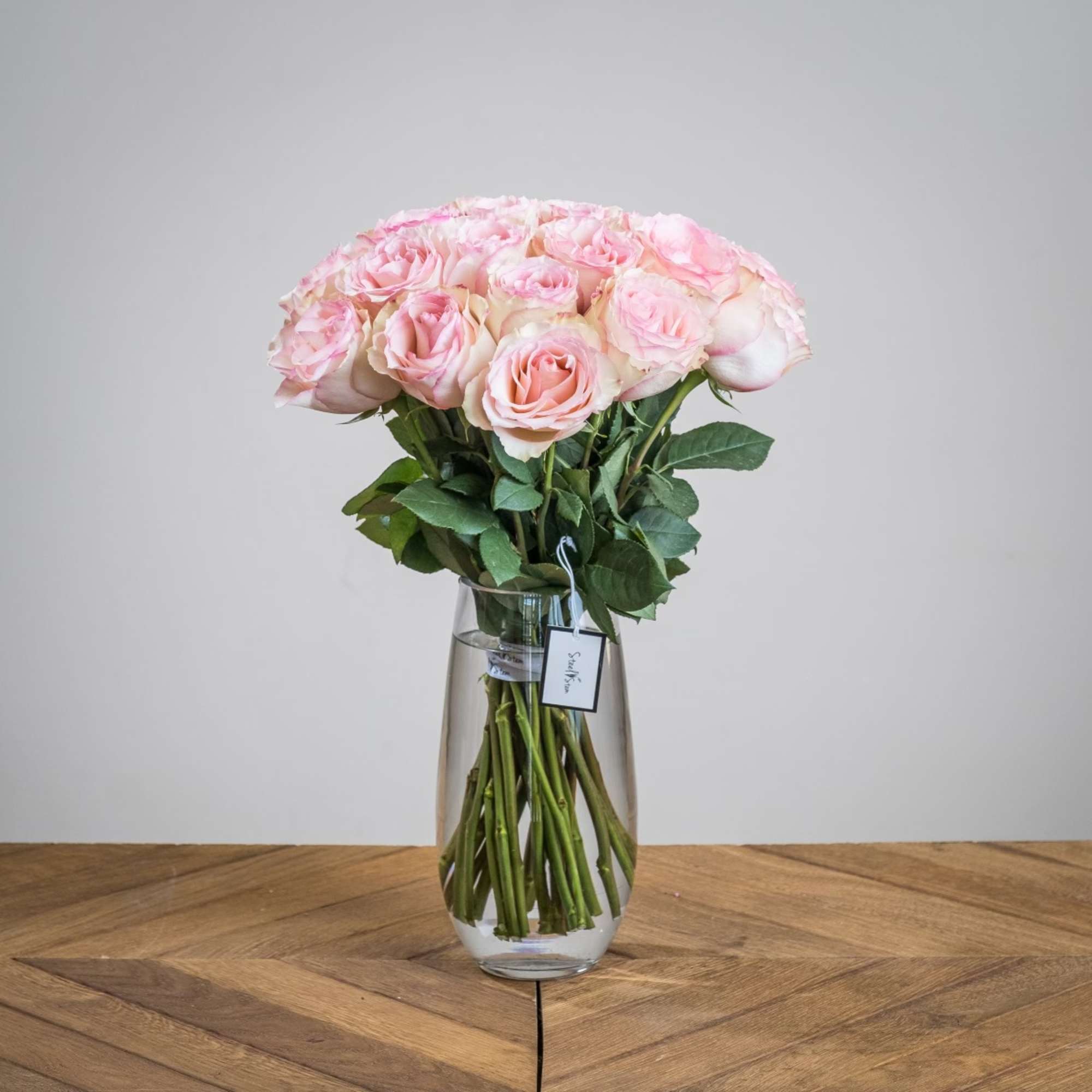 A soft and feminine hand tied bouquet of two dozen premium pastel