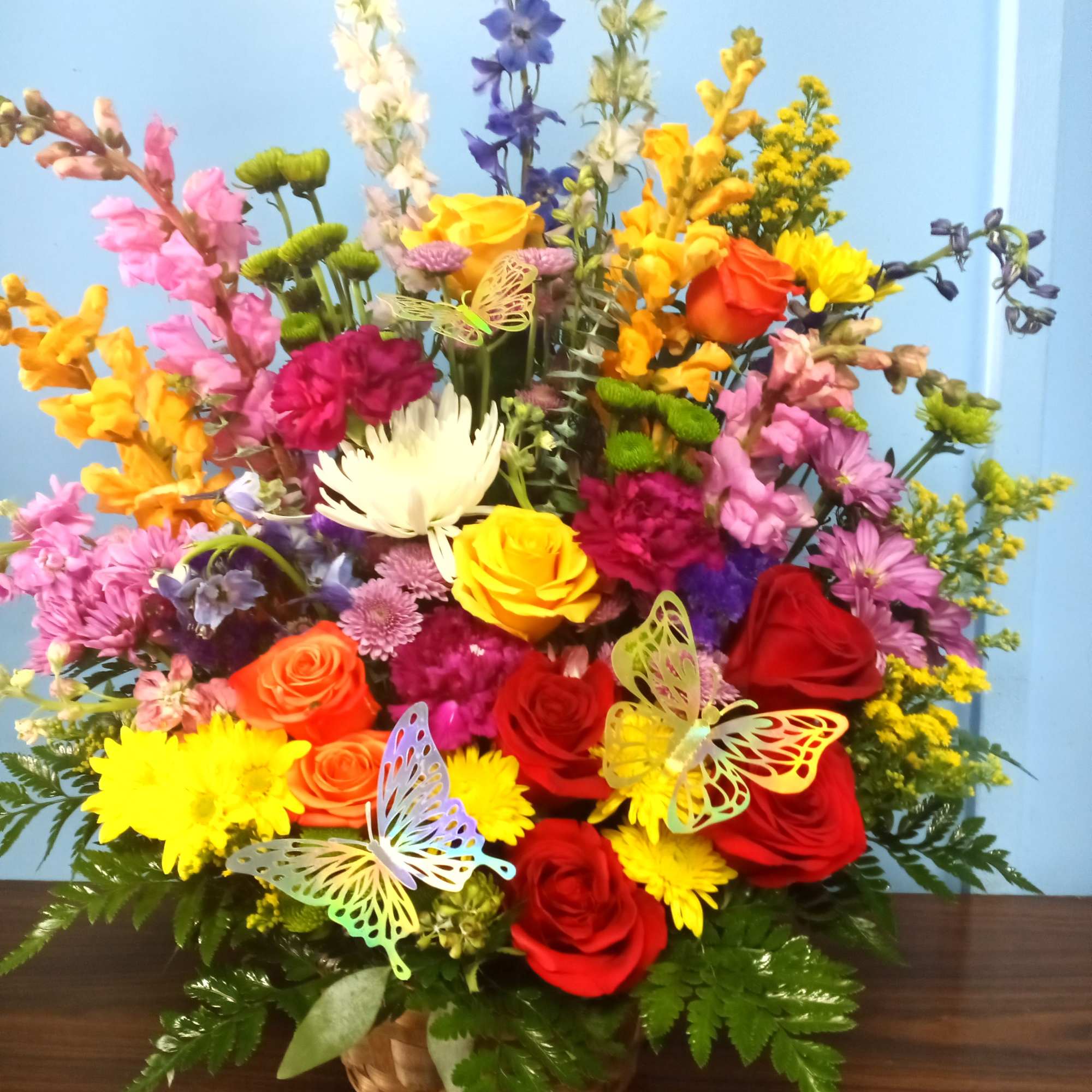 A beautiful mix of fresh flowers with popping colors and accented with
