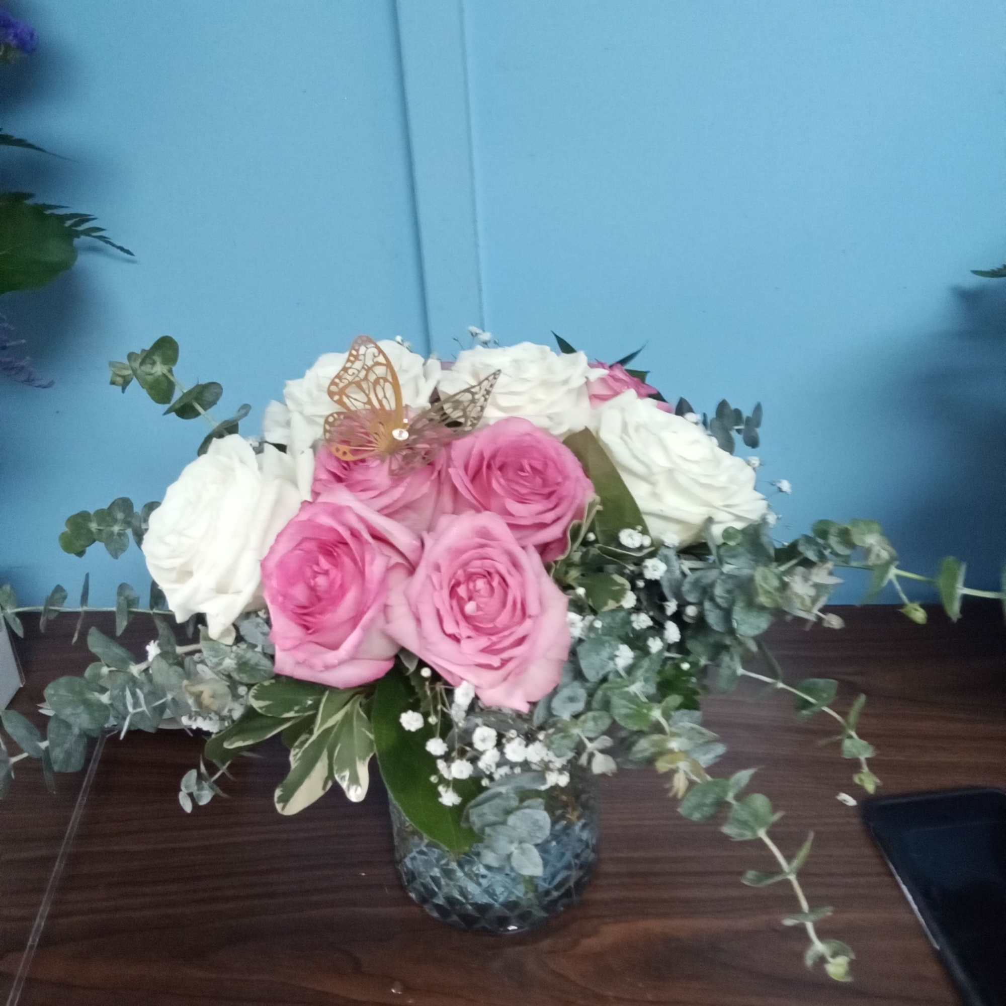 Blush roses with a variety of greenery and eucalyptus come together for