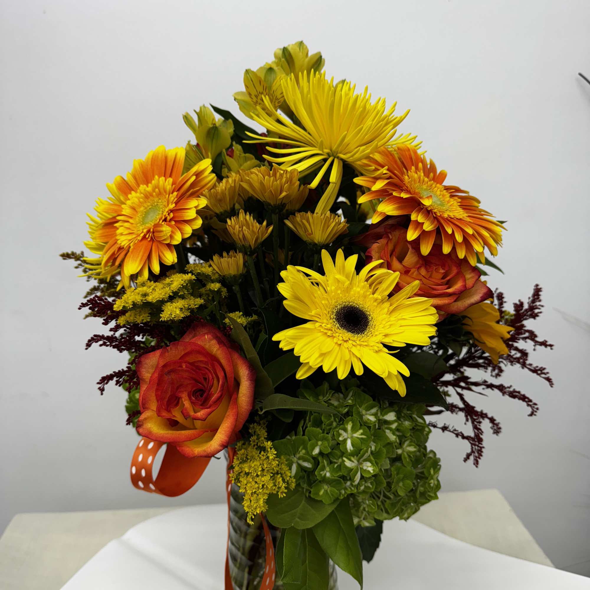  Autumn gladness with this colorful combination of fresh sunflowers, roses, alstroemeria