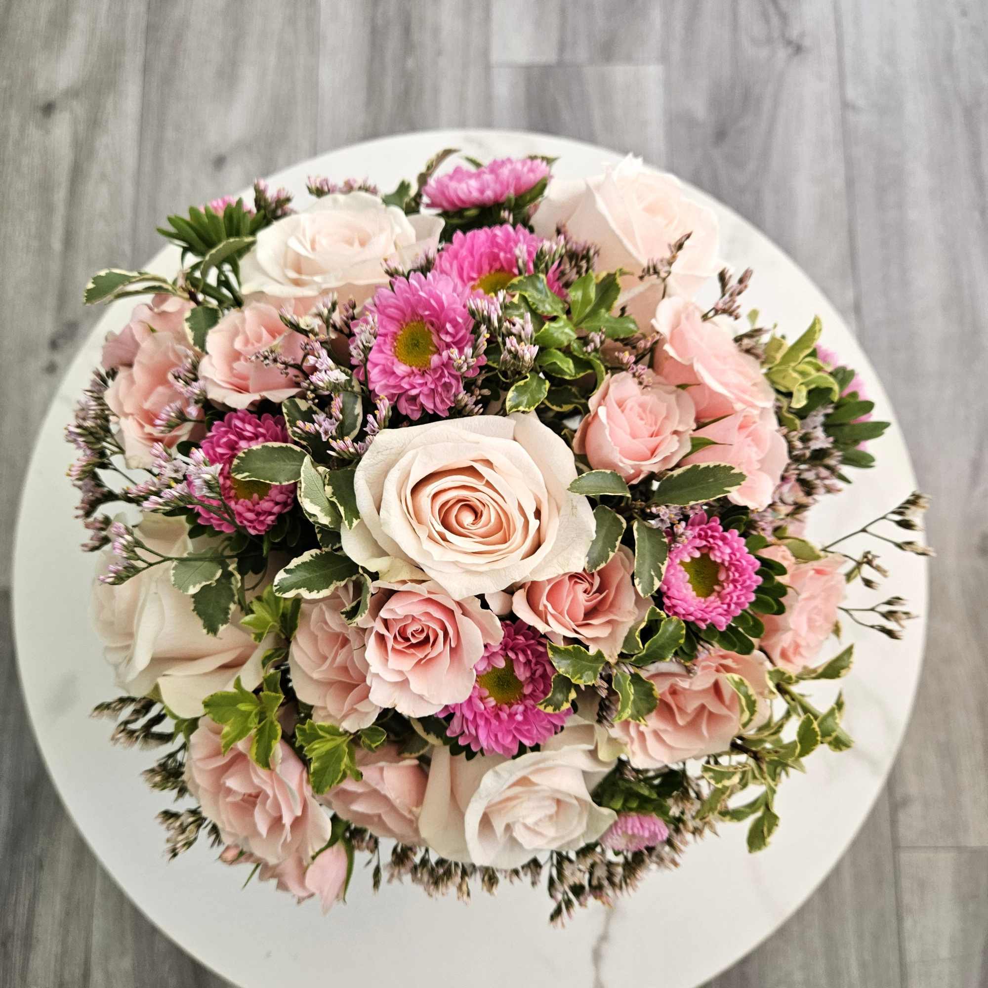 Blush is a romantic dance of soft pink roses and delicate spray