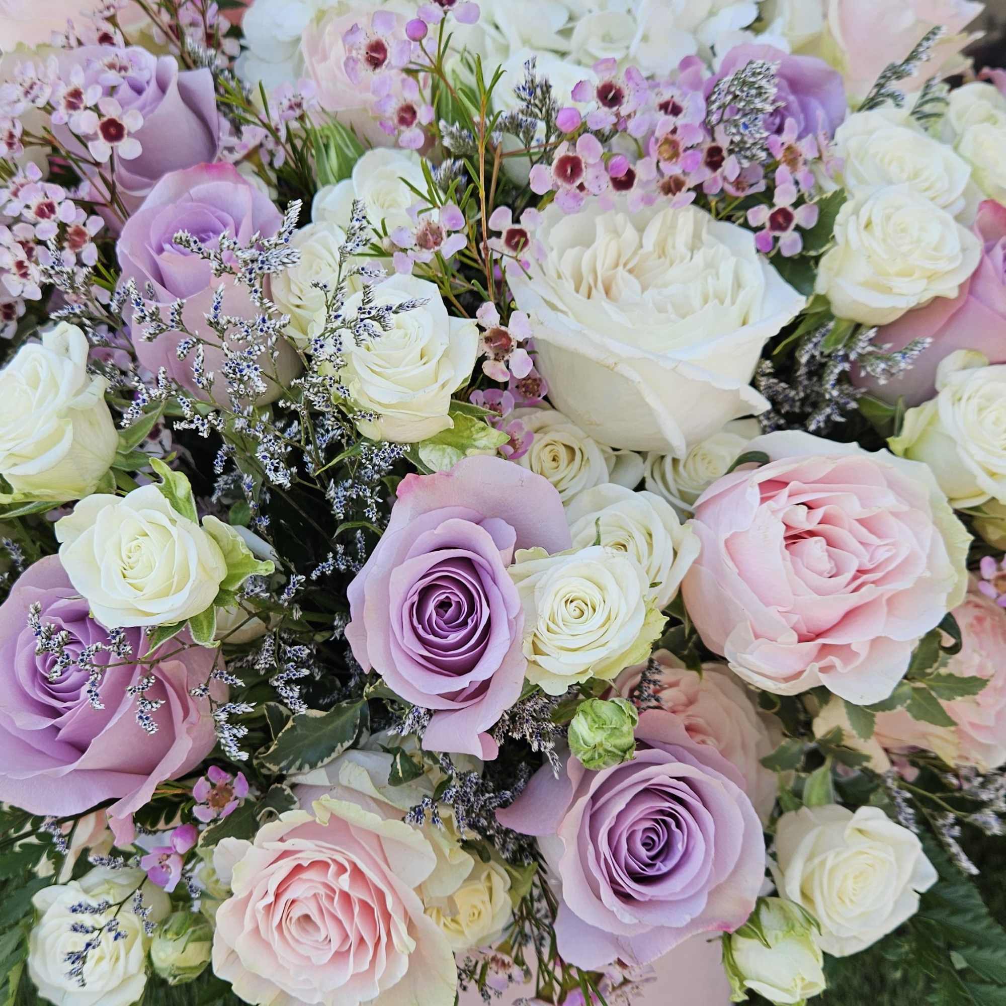 Immerse yourself in the delicate romance of soft beige and lavender roses