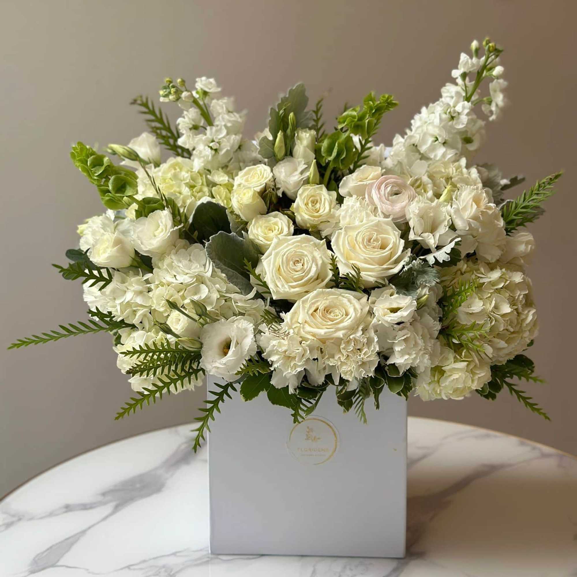Our Bestseller - is an elegant White Mix arrangement, featuring white roses