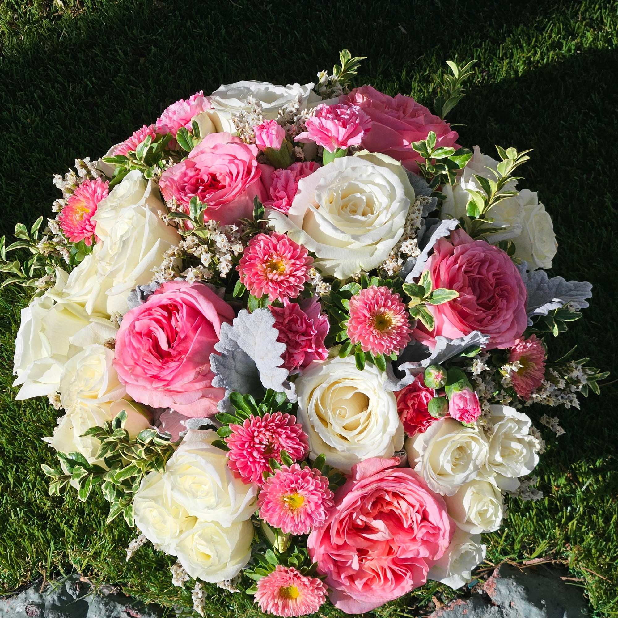 A symphony of pink and white roses gracefully arranged in a sleek