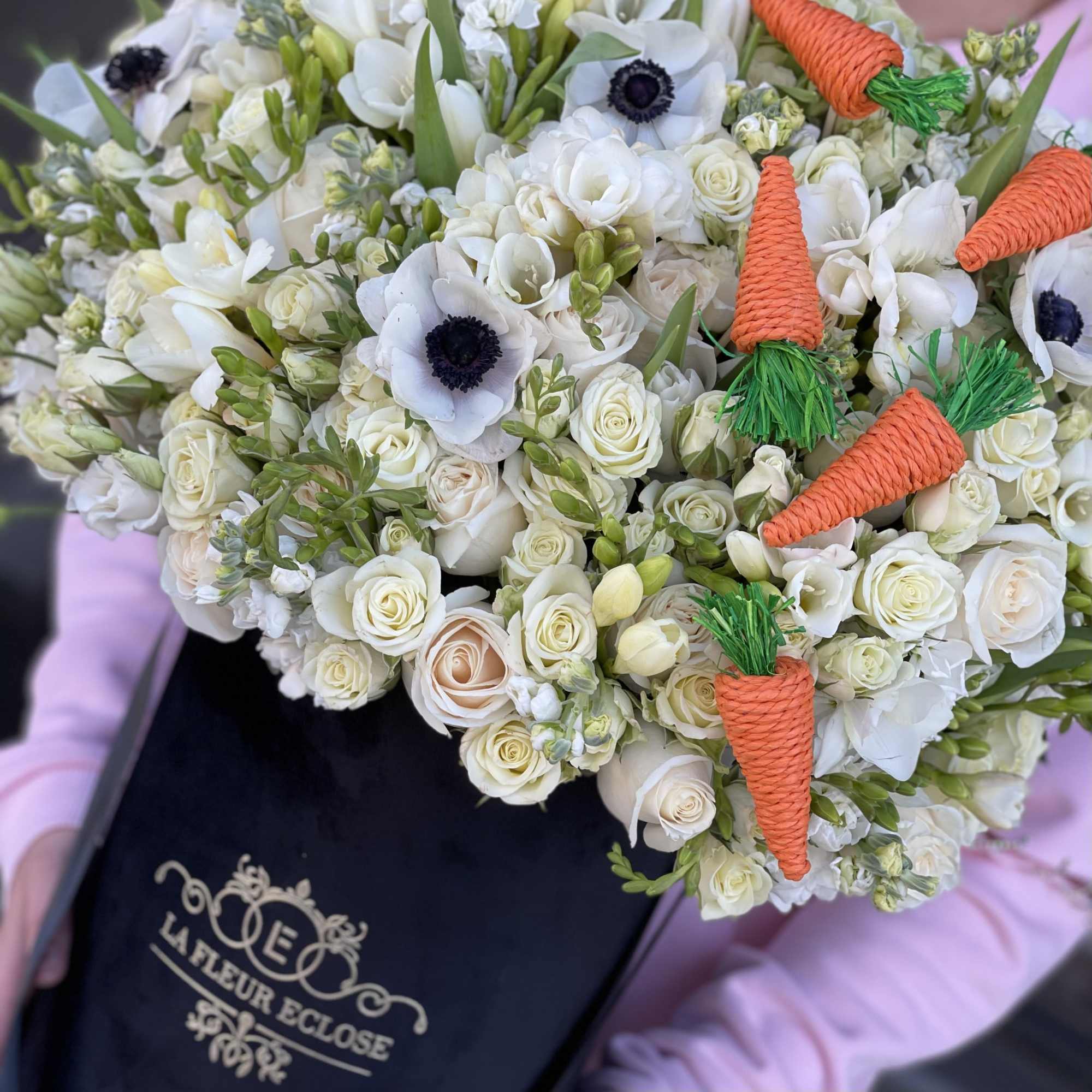 All white arrangement with carrots for Easter