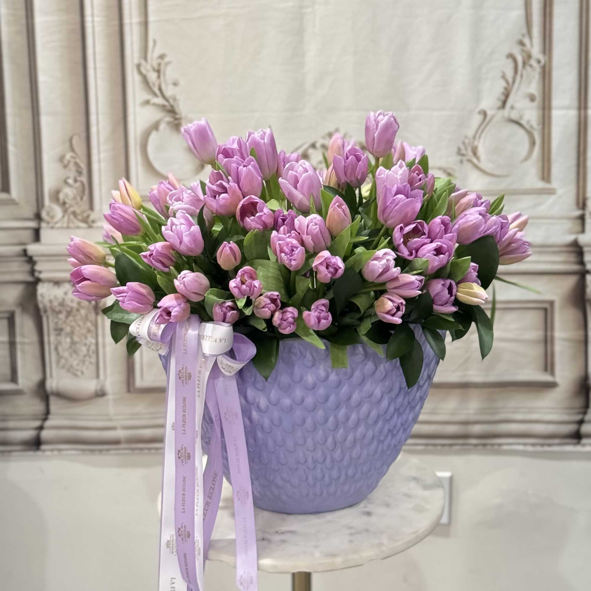 90 lavender tulips in a lavender vase