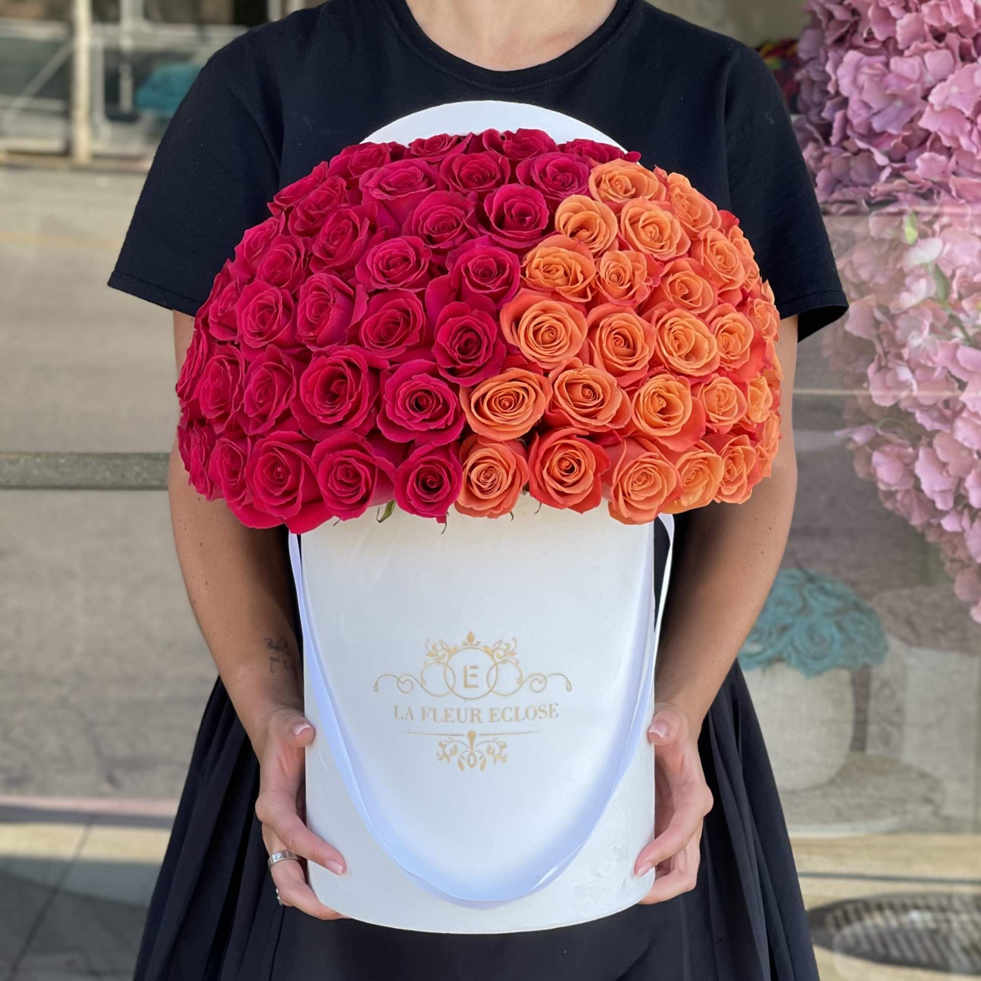 50 roses of pink and orange colors in our signature velvet white