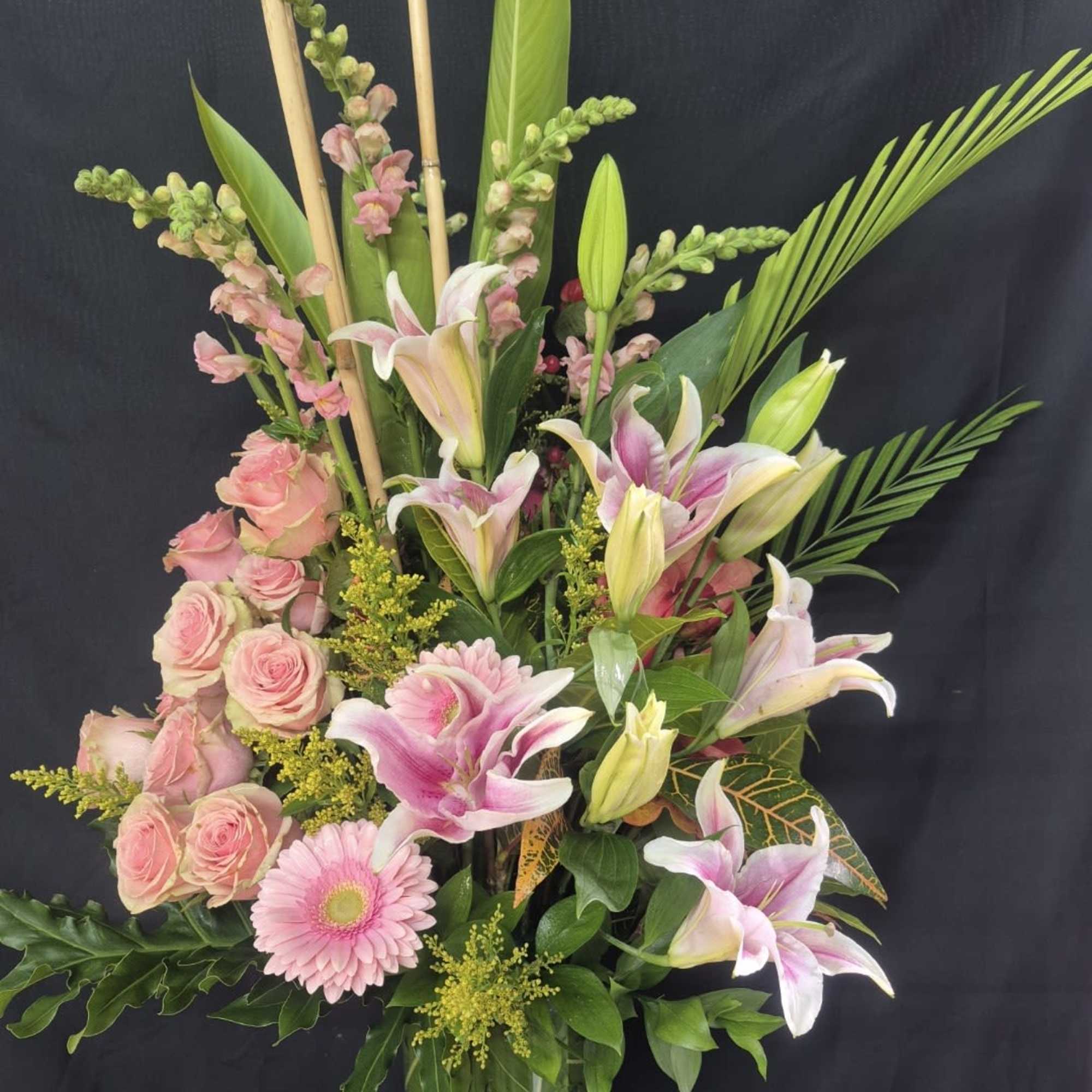 This stunning 360-degree arrangement stands approximately 28-30 ins tall and makes a