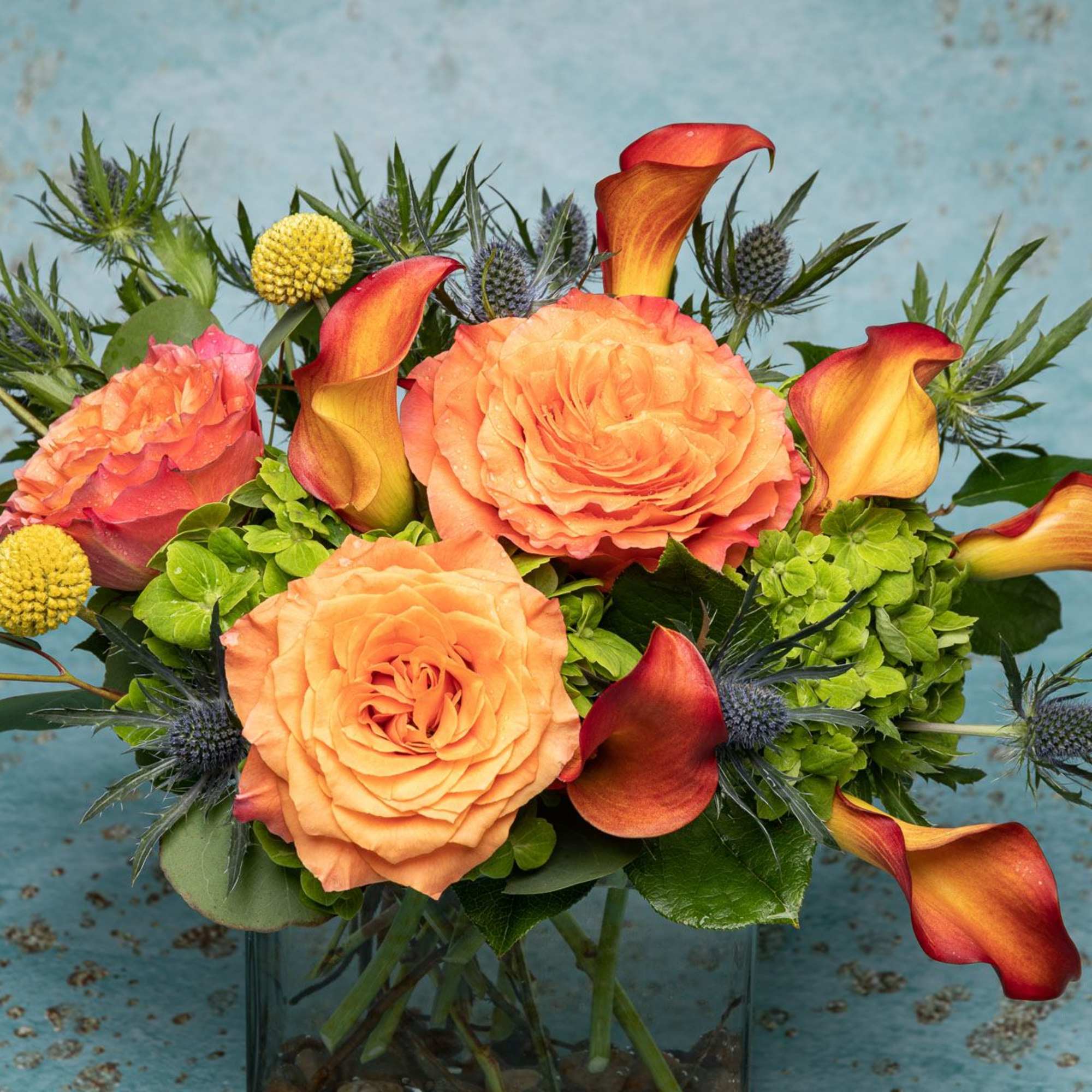 Enjoy this Hot and very bold orange fire free sprit arrangement. With