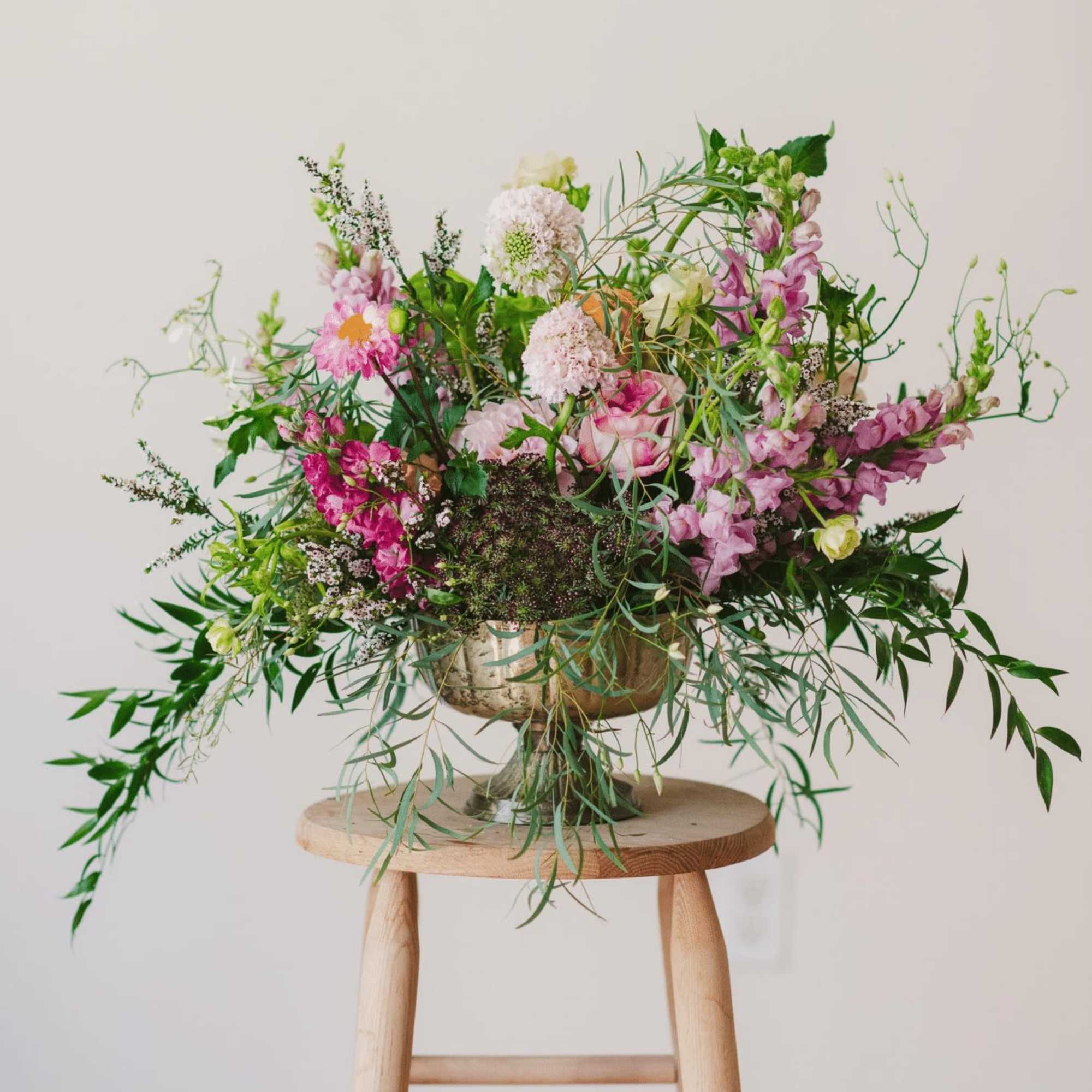 Anthuriums sing in this colorful composition, nestled between dancing butterfly ranunculus, queen