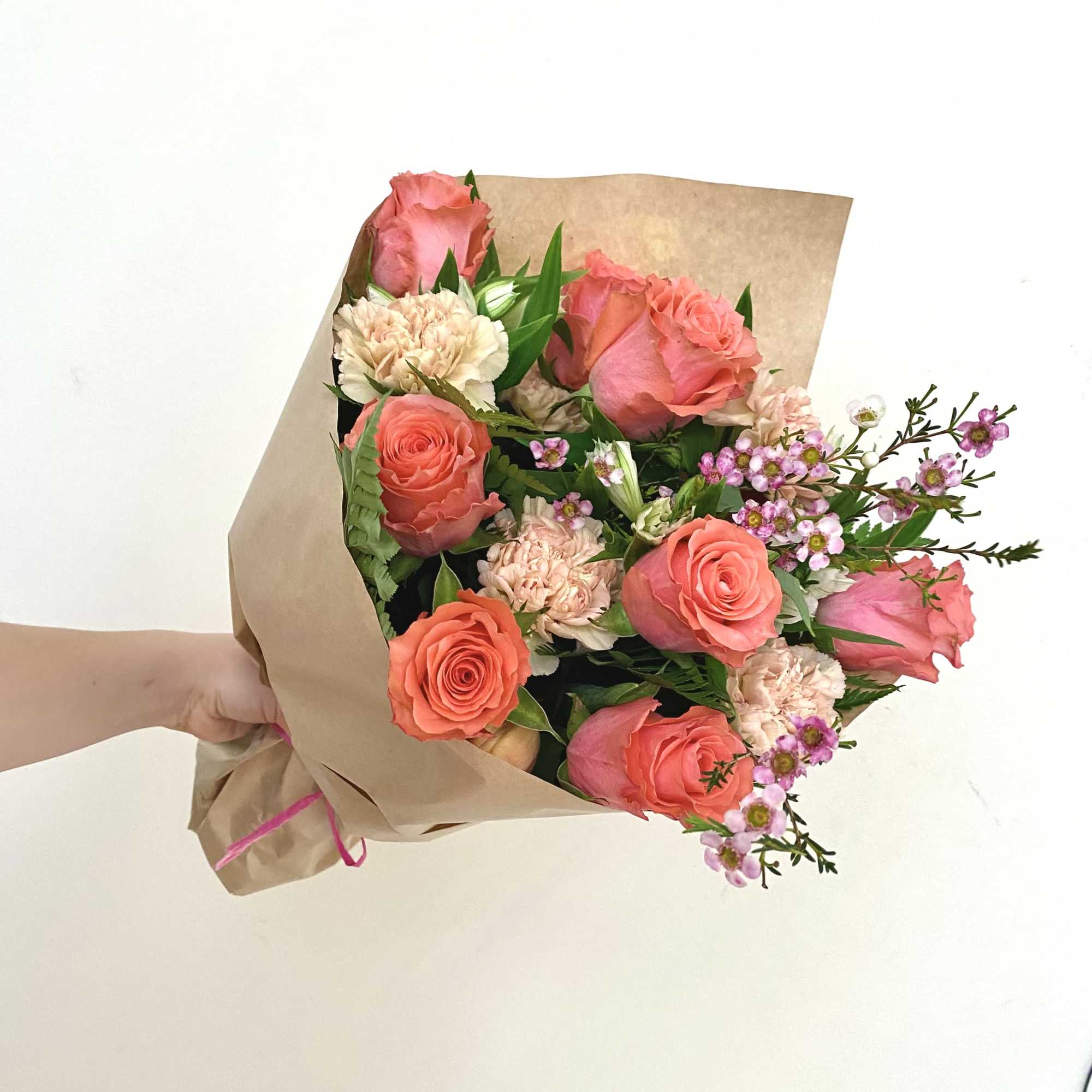 12 premium roses in a perfectly mixed hand tied bouquet. Wax flower