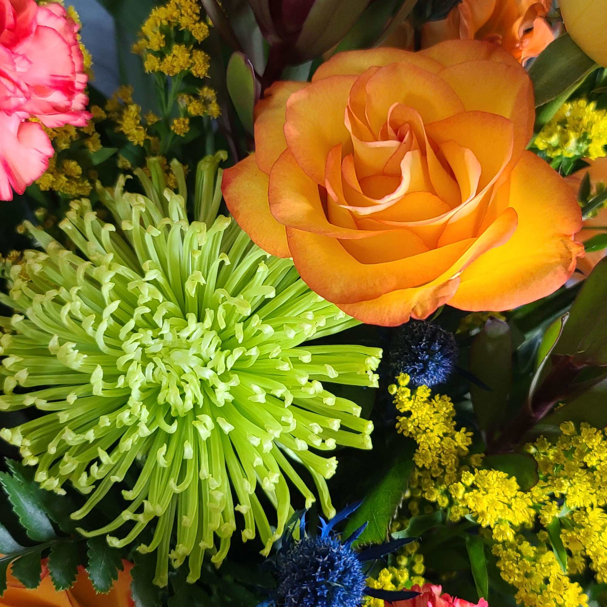 Lilies, roses, safari sunset, and other flowers.  Hues of orange colored