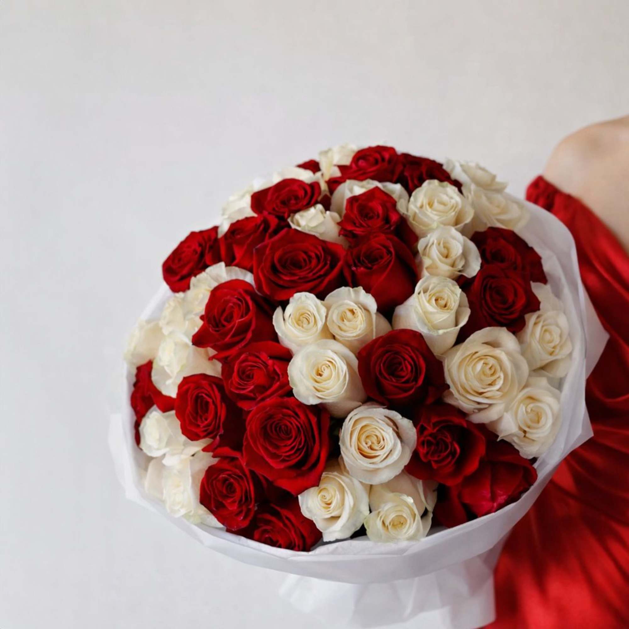 A striking harmony of passionate red and  white roses, beautifully wrapped