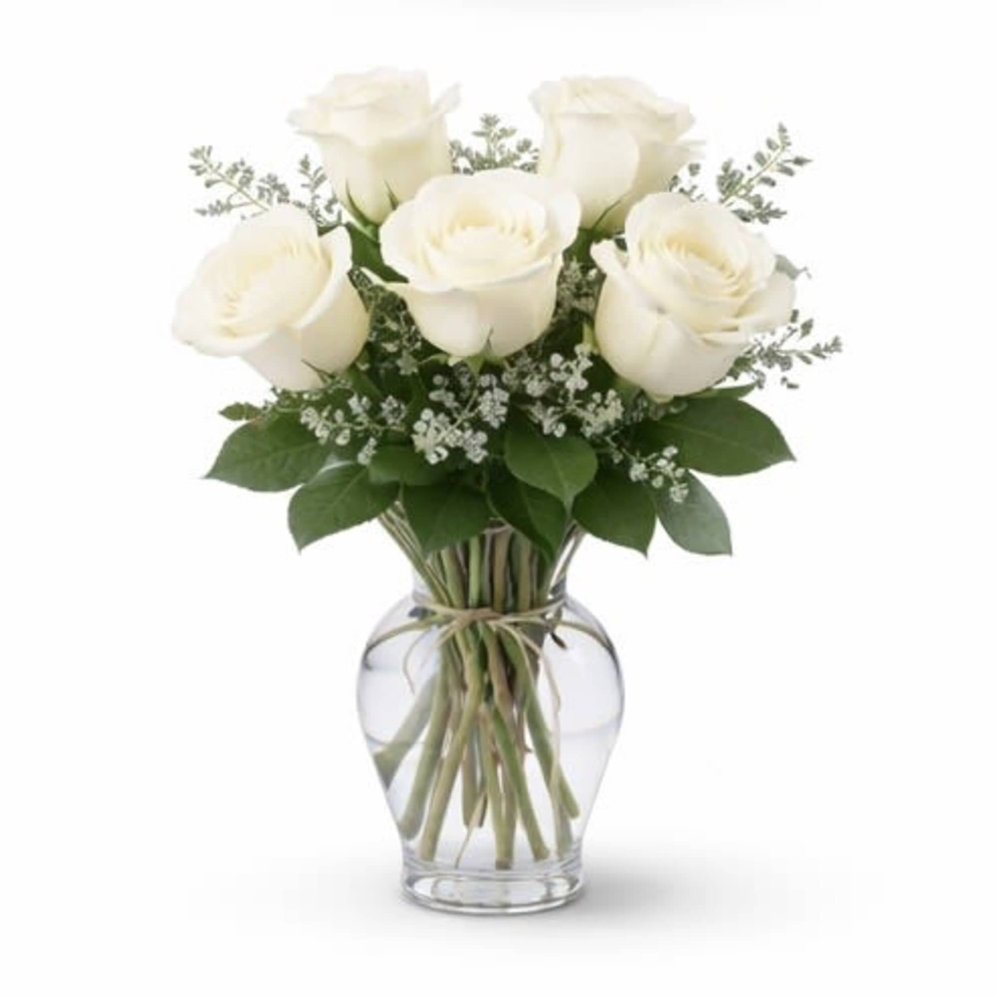 Crisp white roses arranged in a clear glass vase with fresh greenery