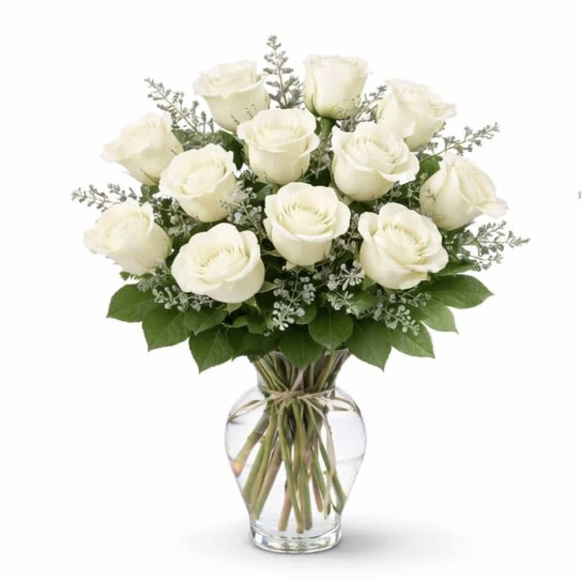 Crisp white roses arranged in a clear glass vase with fresh greenery
