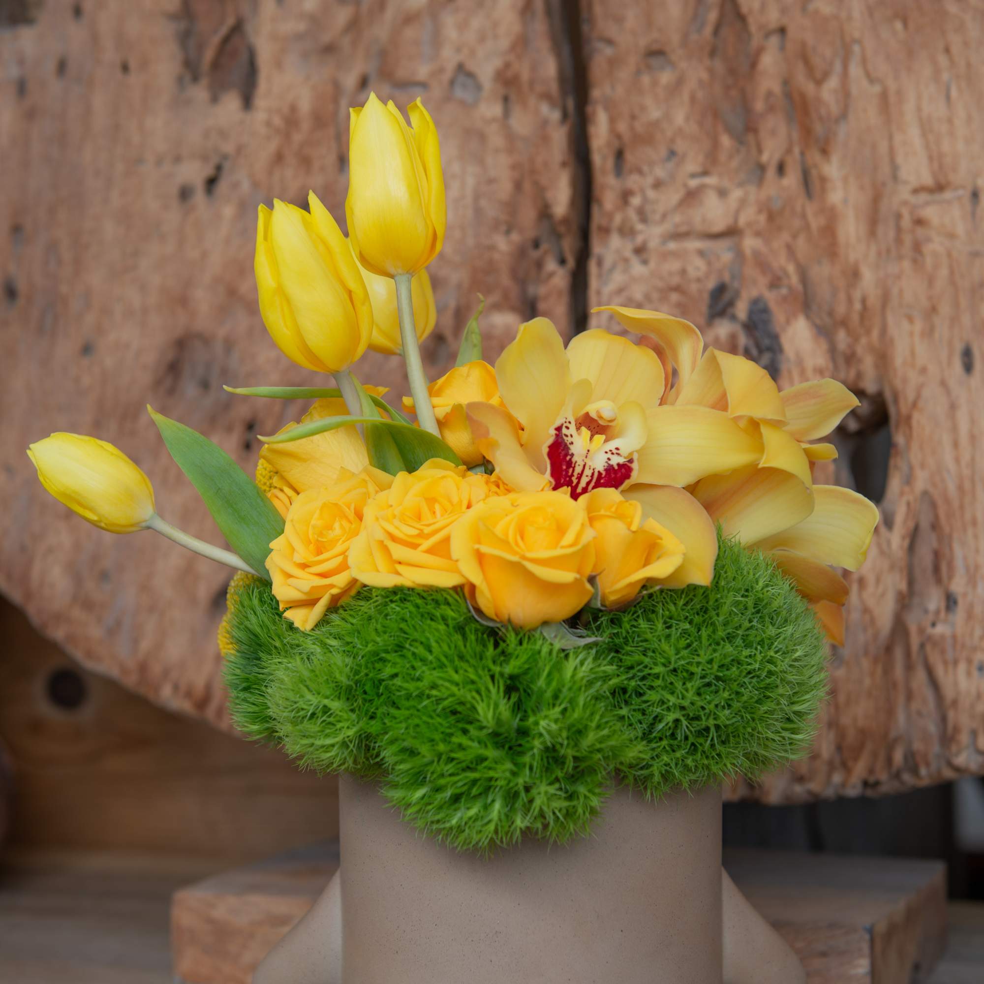 Our delicate ceramic hunny bear vase filled with the seasons yellow blooms.