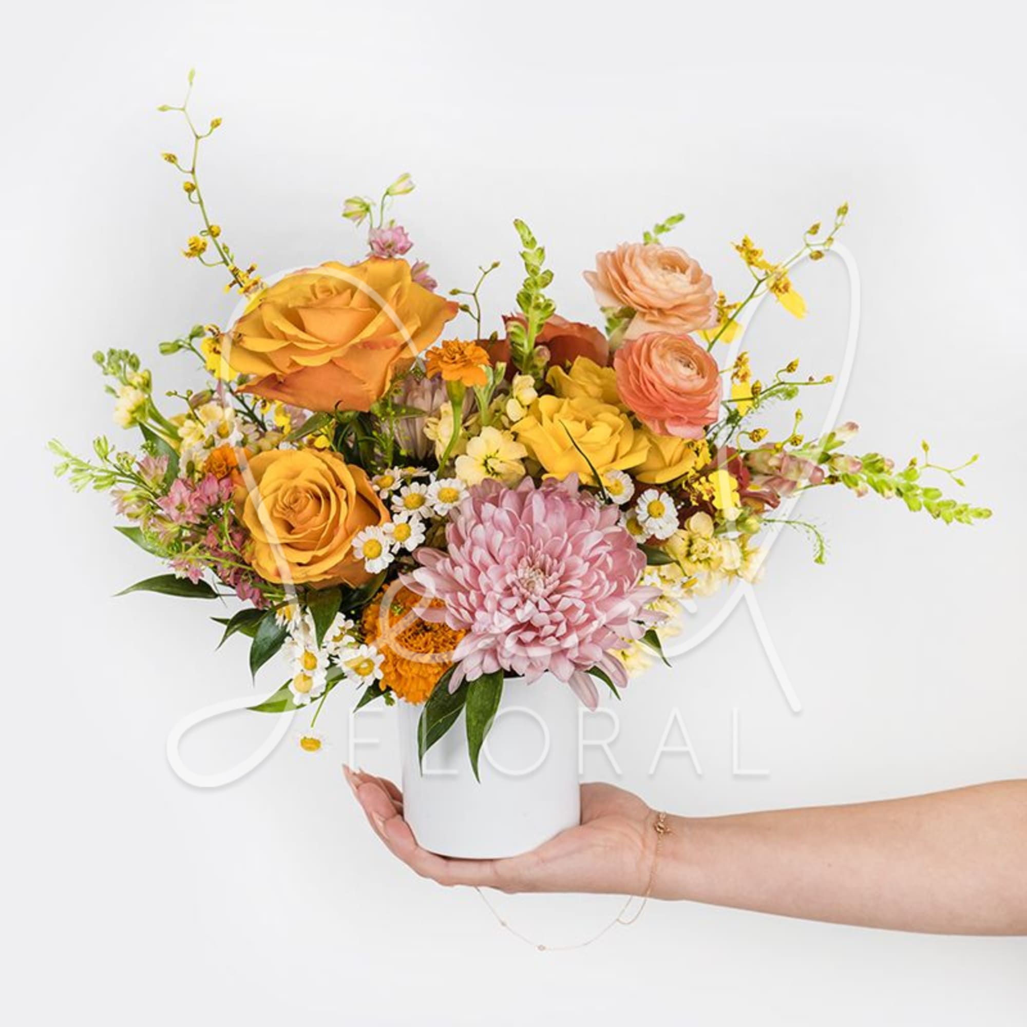Our Petite Seasonal Arrangement features pretty vibrant seasonal blooms, making it the