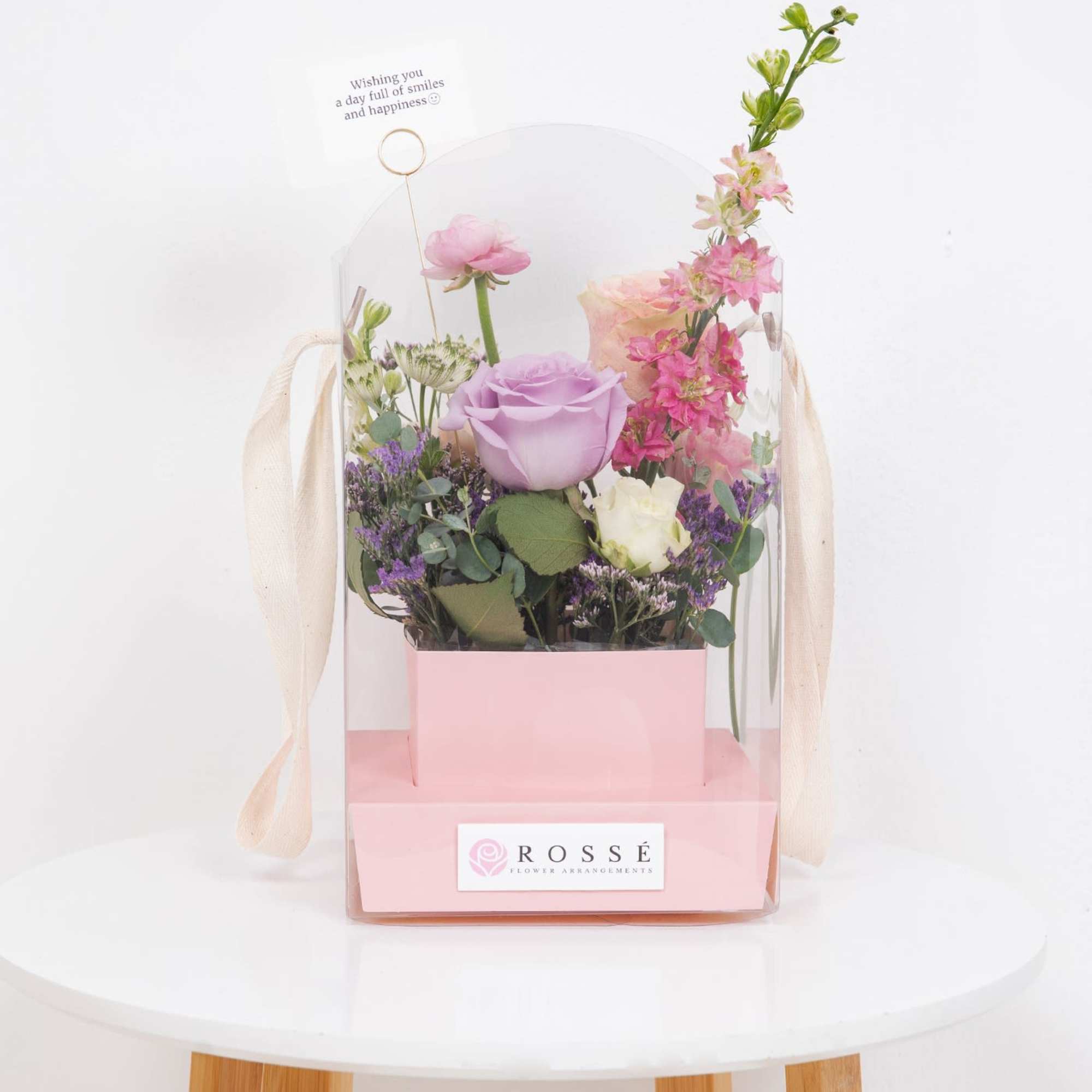 A Flowers bag featuring a soft pastel-colored box paired with an arched