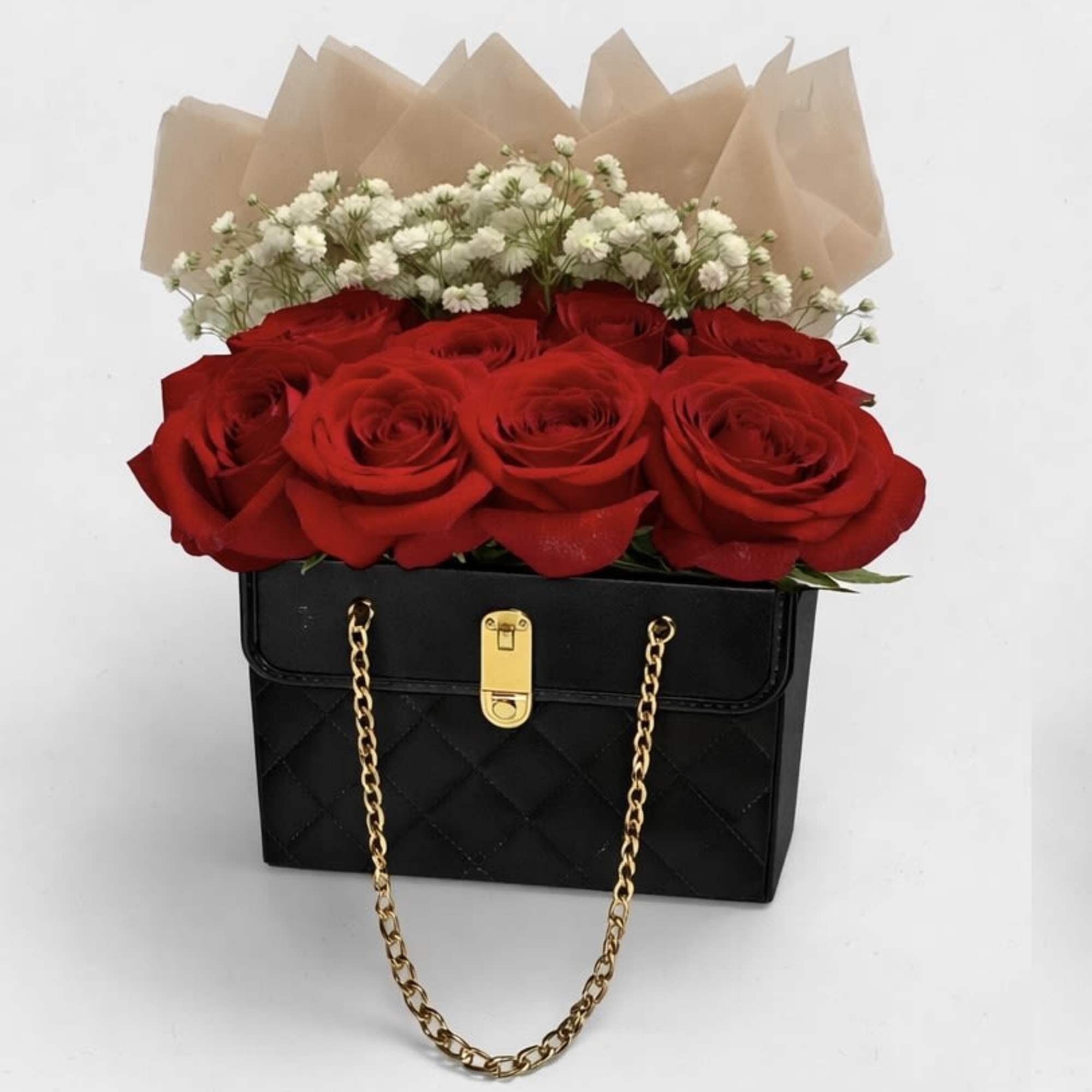 An exquisite arrangement of lush red roses and delicate baby&rsquo;s breath, beautifully