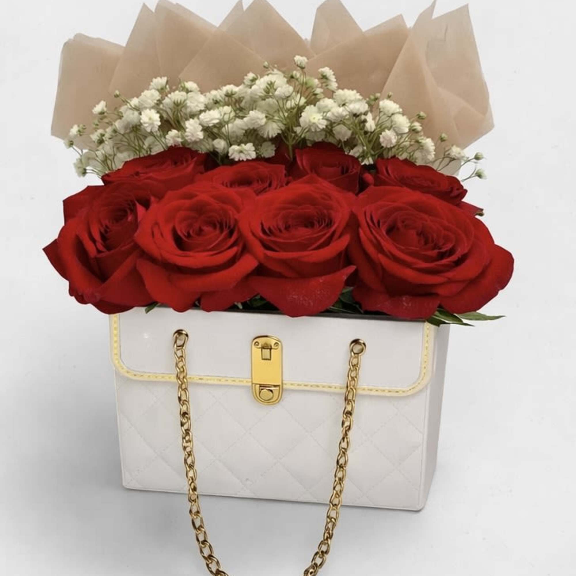 An exquisite arrangement of lush red roses and delicate baby&rsquo;s breath, beautifully