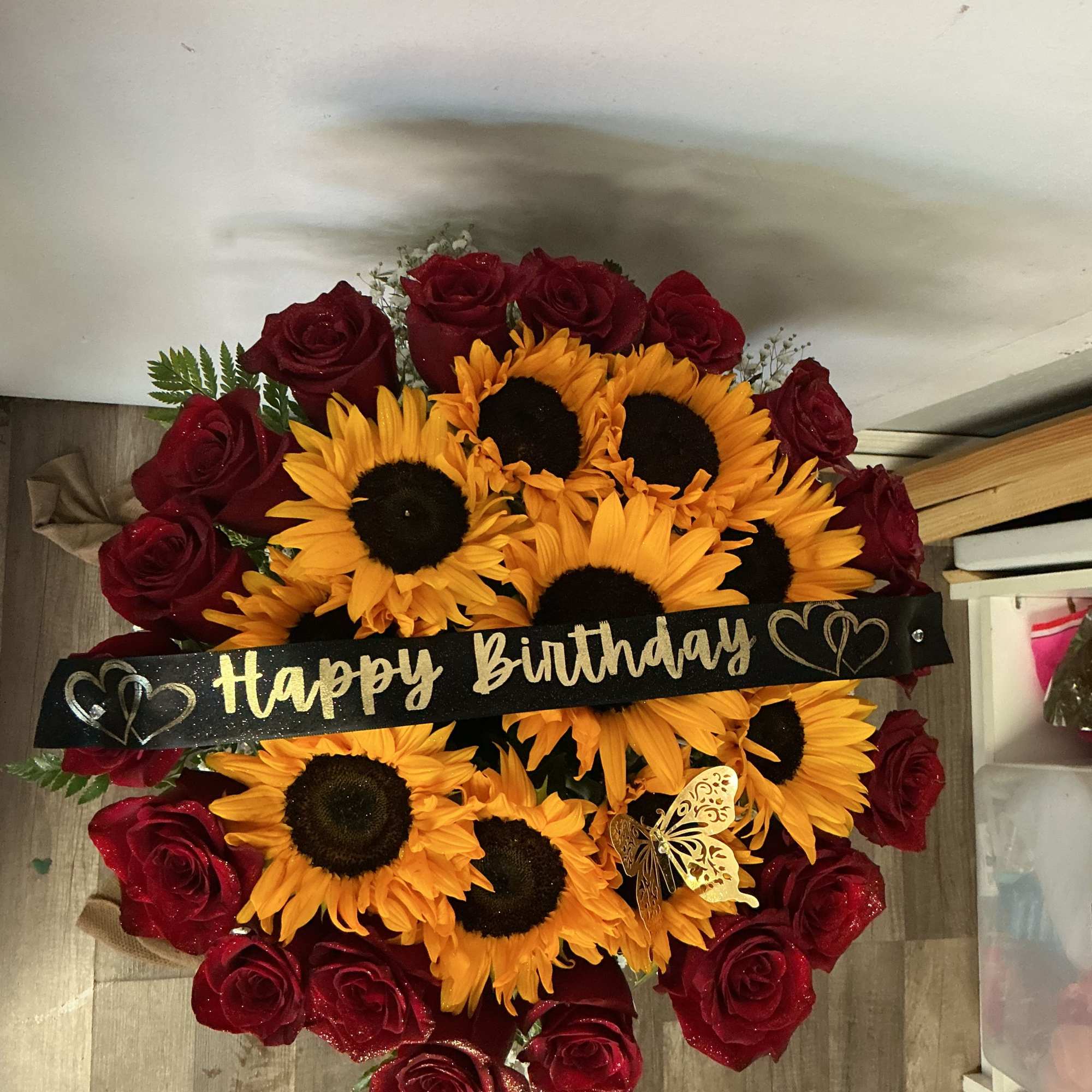 This great gift is made of beautiful sunflowers and red roses but