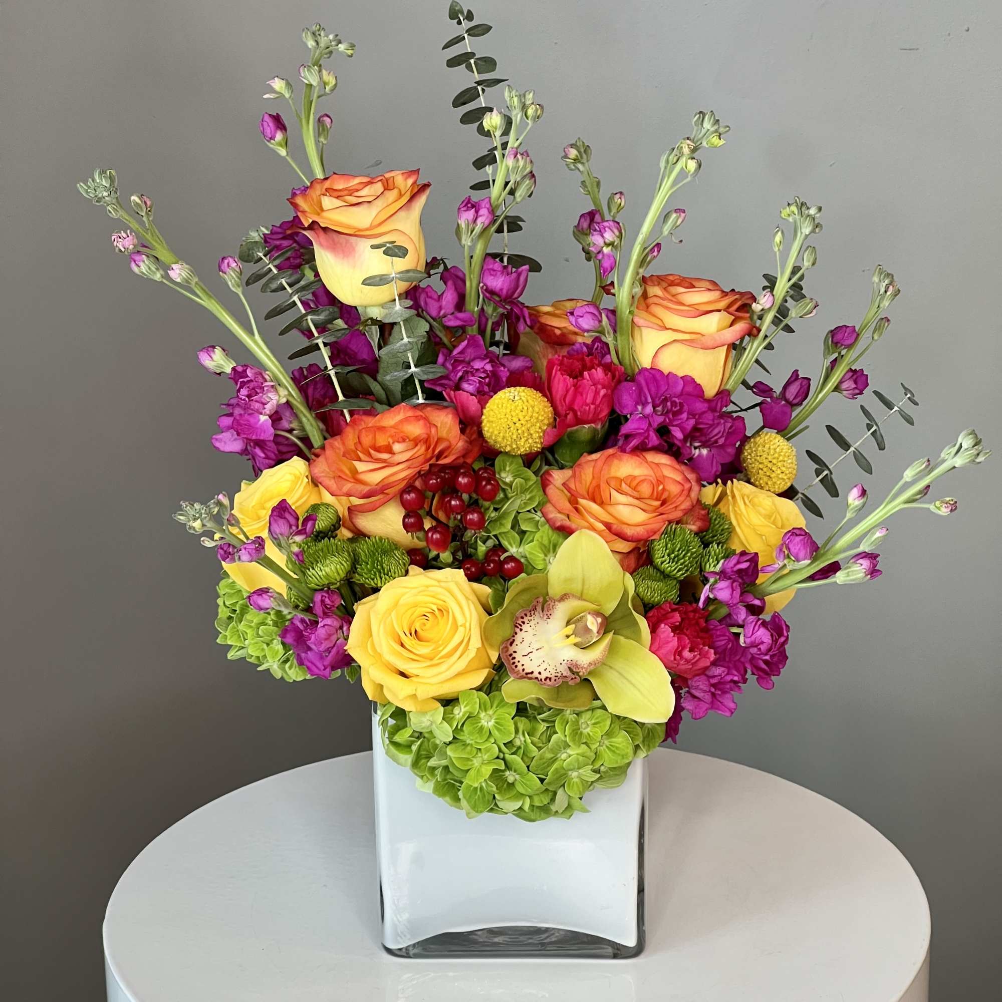 Turn up the heat with the vivacious bouquet. This arrangement includes roses
