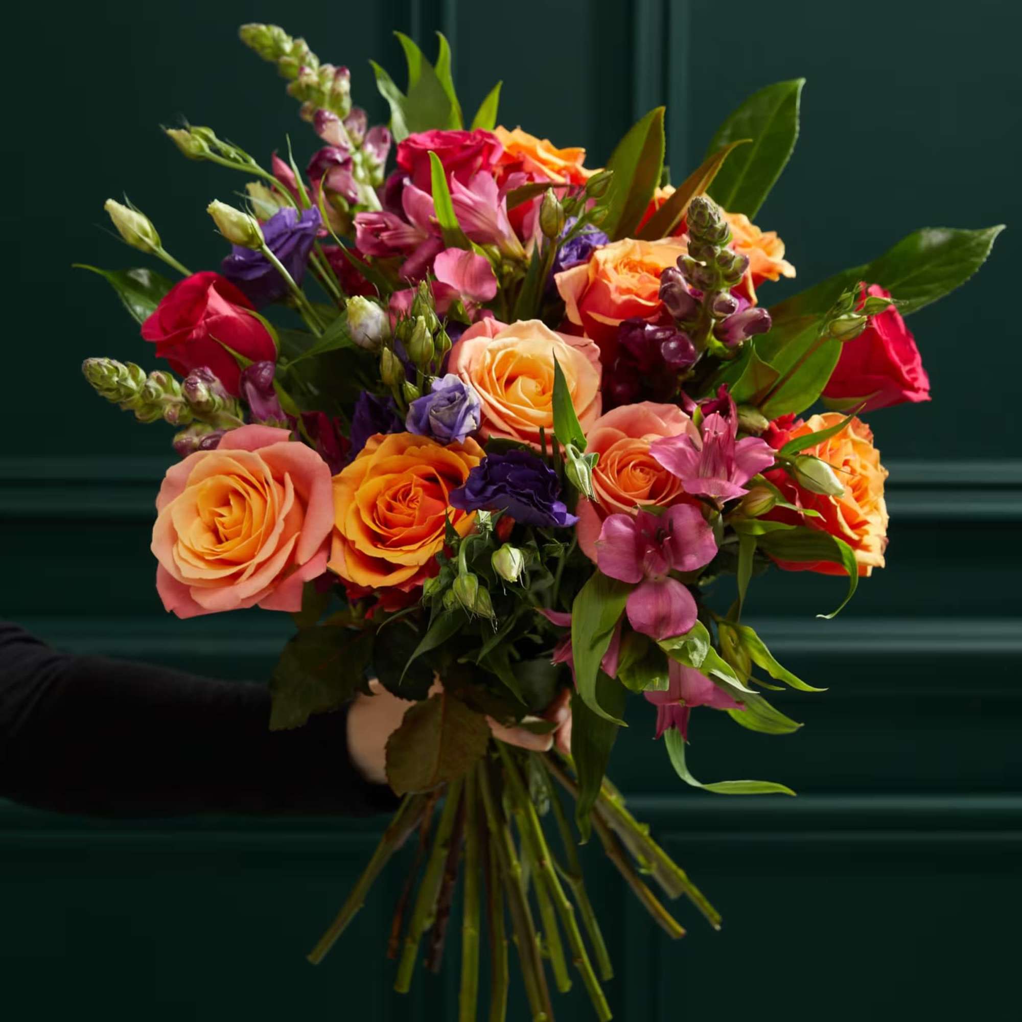 Hand-tied bouquet of orange, pink, and purple flowers