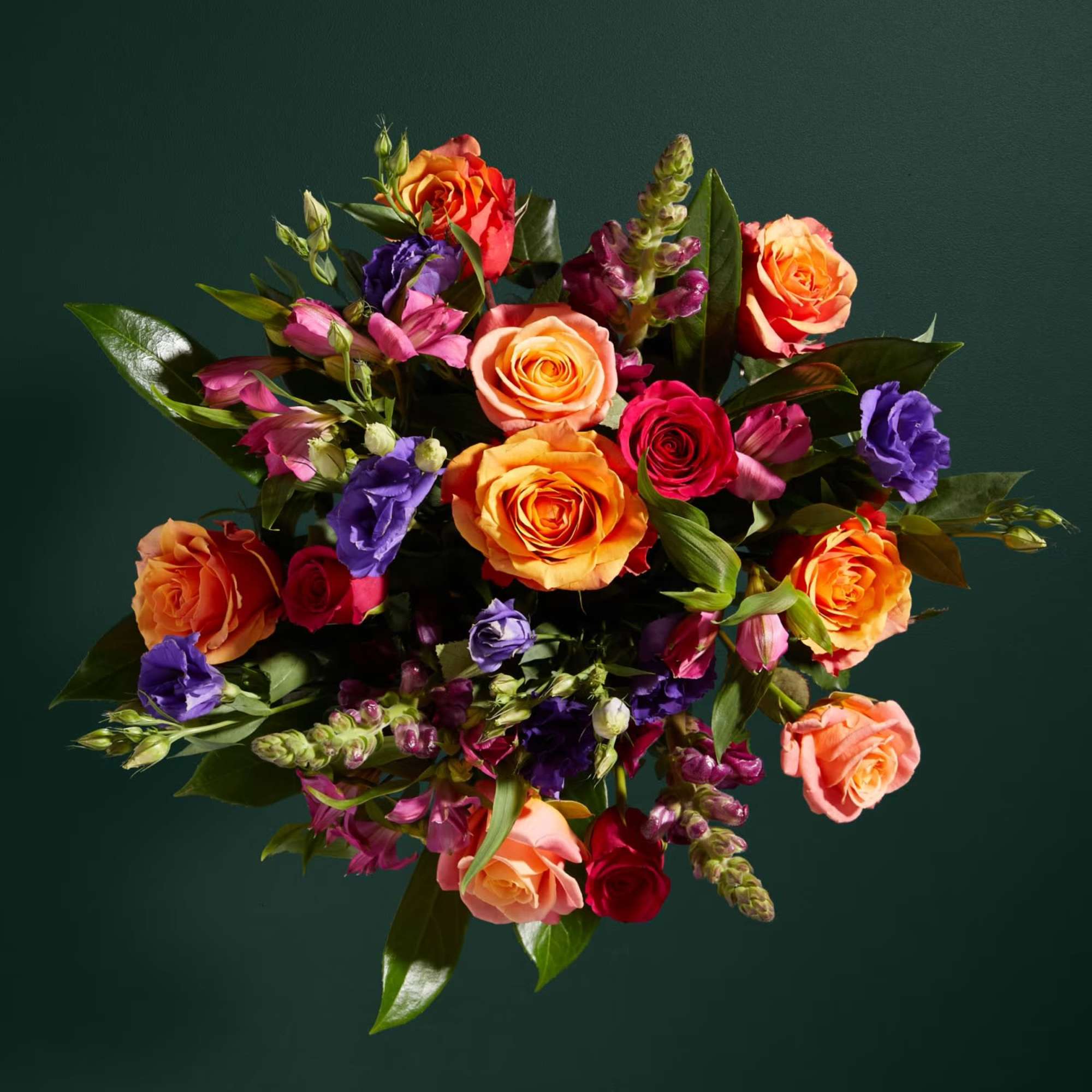 Bouquet of orange, pink, and purple roses with mixed blooms