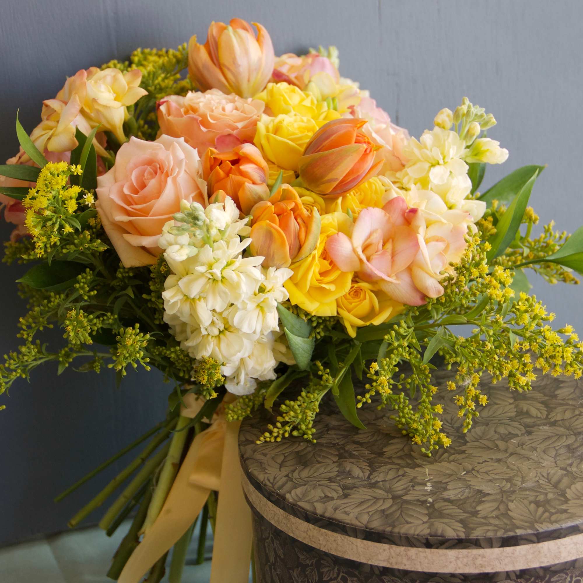 A lovely garden style bouquet in peach and soft yellow tones. Romantic