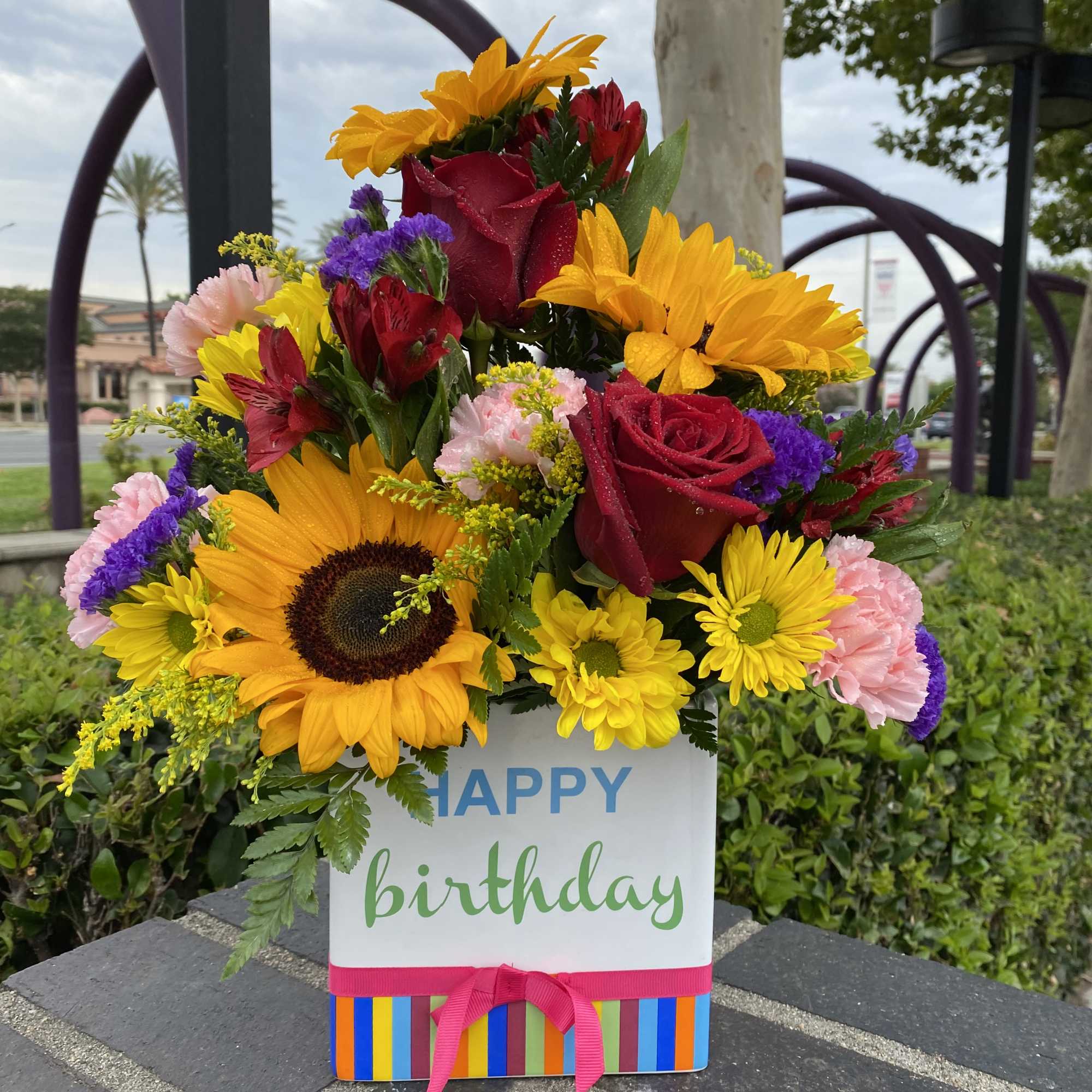 Happy birthday keepsake container and beautiful flower arrangement consisting of in season
