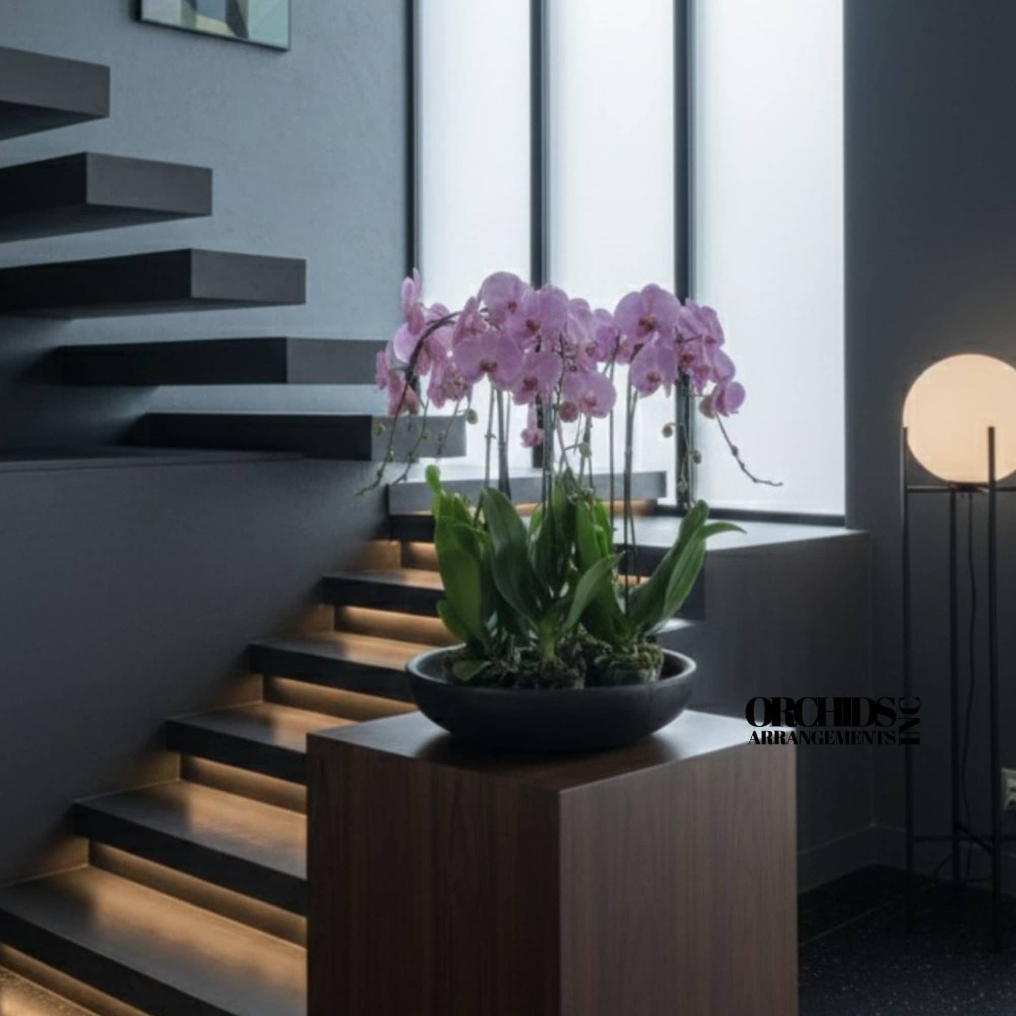 A high quality Nine pink orchids arrangement with a vase 20" D