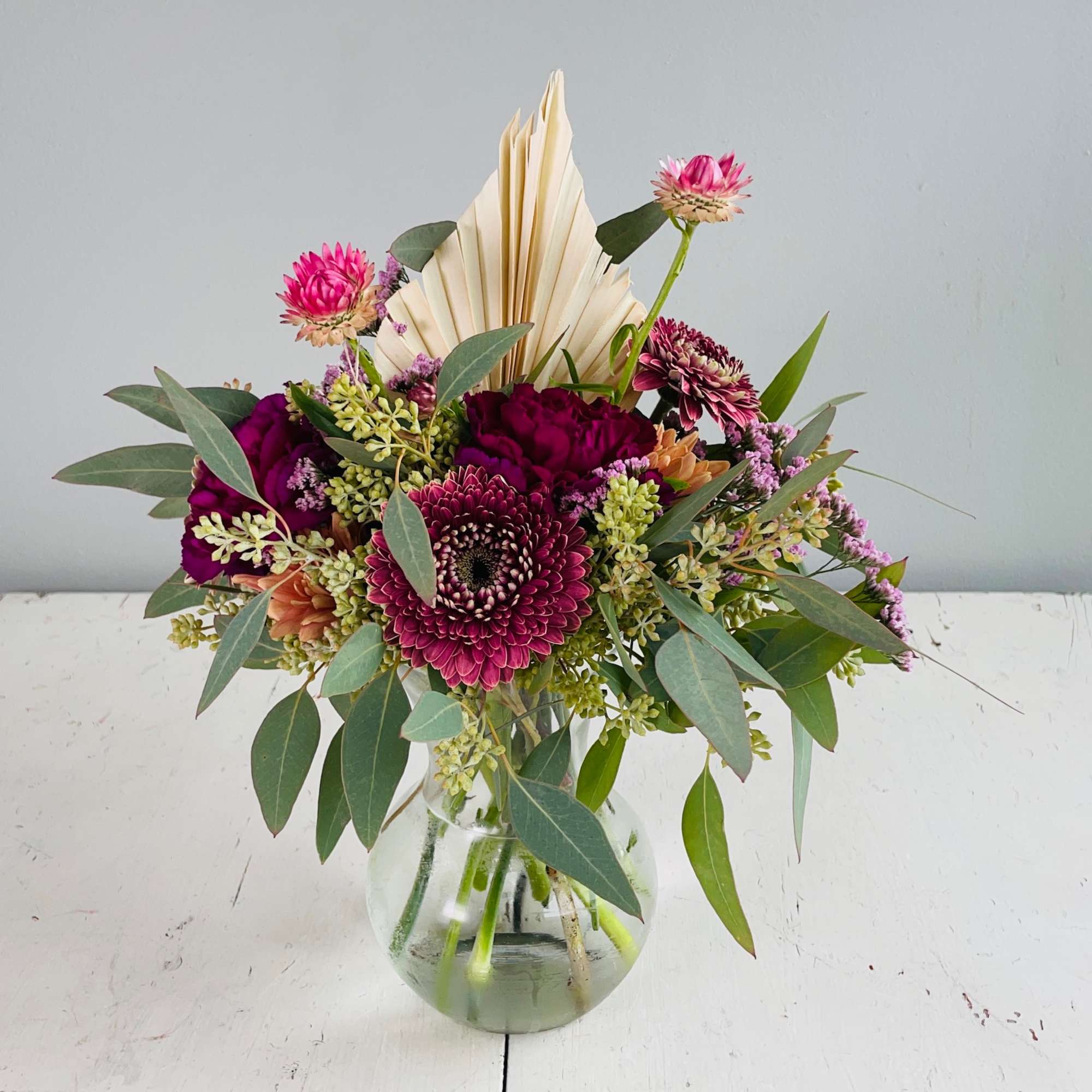 She is petite and pretty with a mix of berry toned blooms!