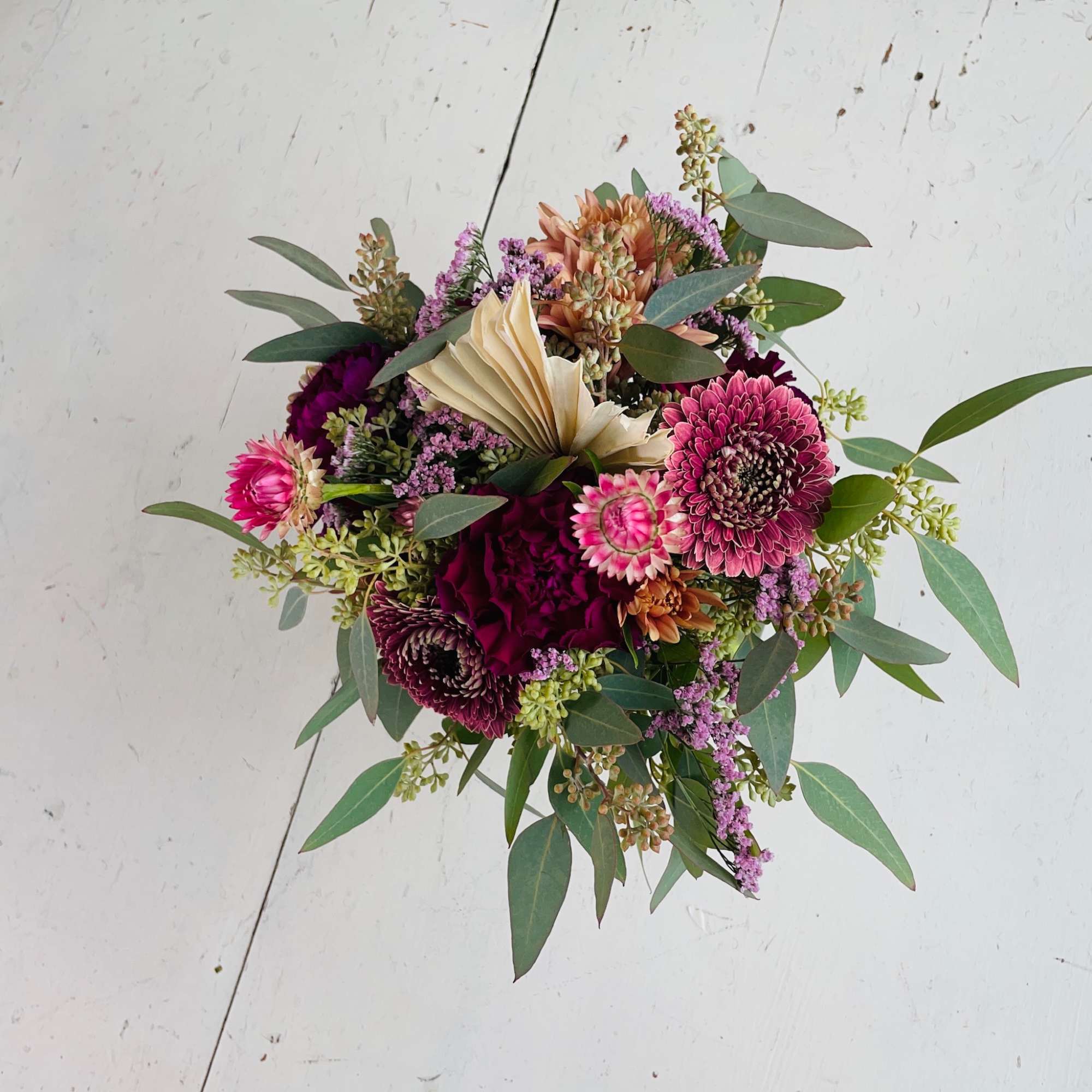 She is petite and pretty with a mix of berry toned blooms!