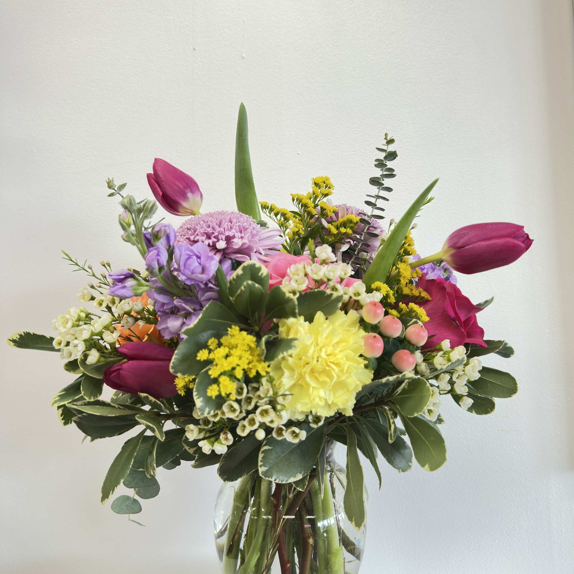 "Mom in Full Bloom" is a vibrant, multi-textured arrangement designed to celebrate