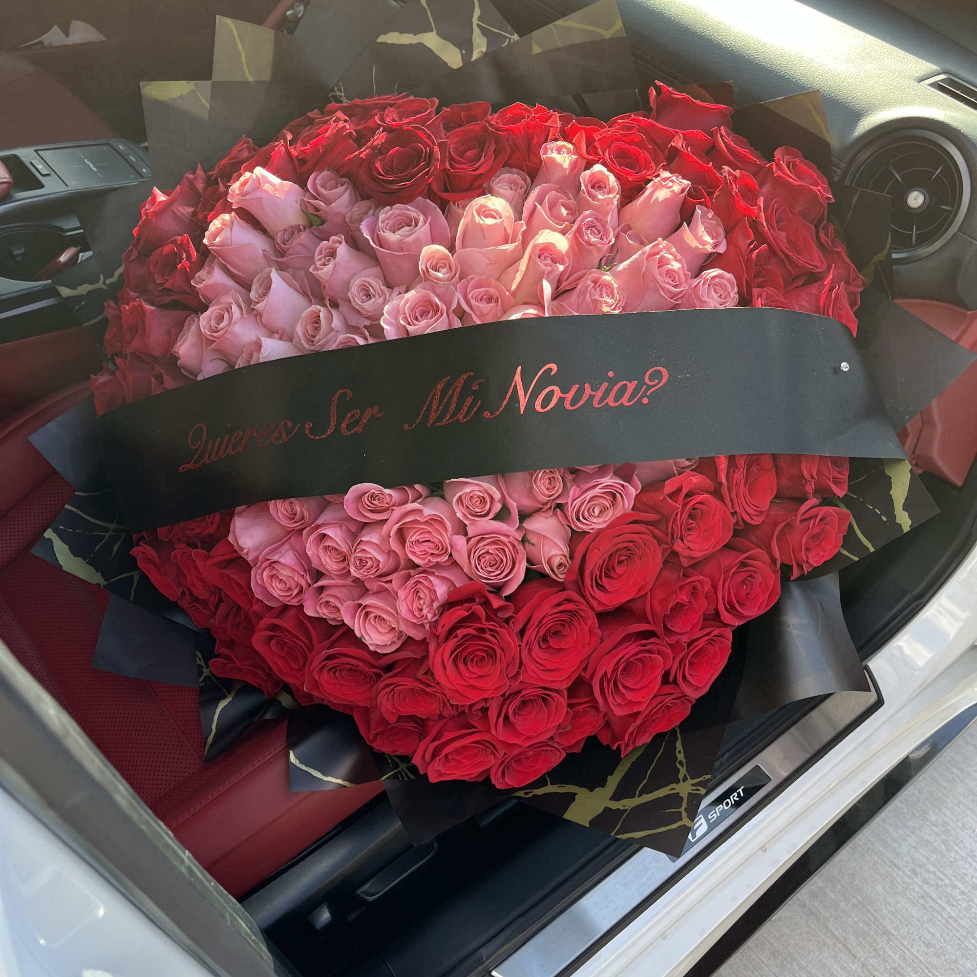 averages 100 total roses in a heart shape; a pink center with