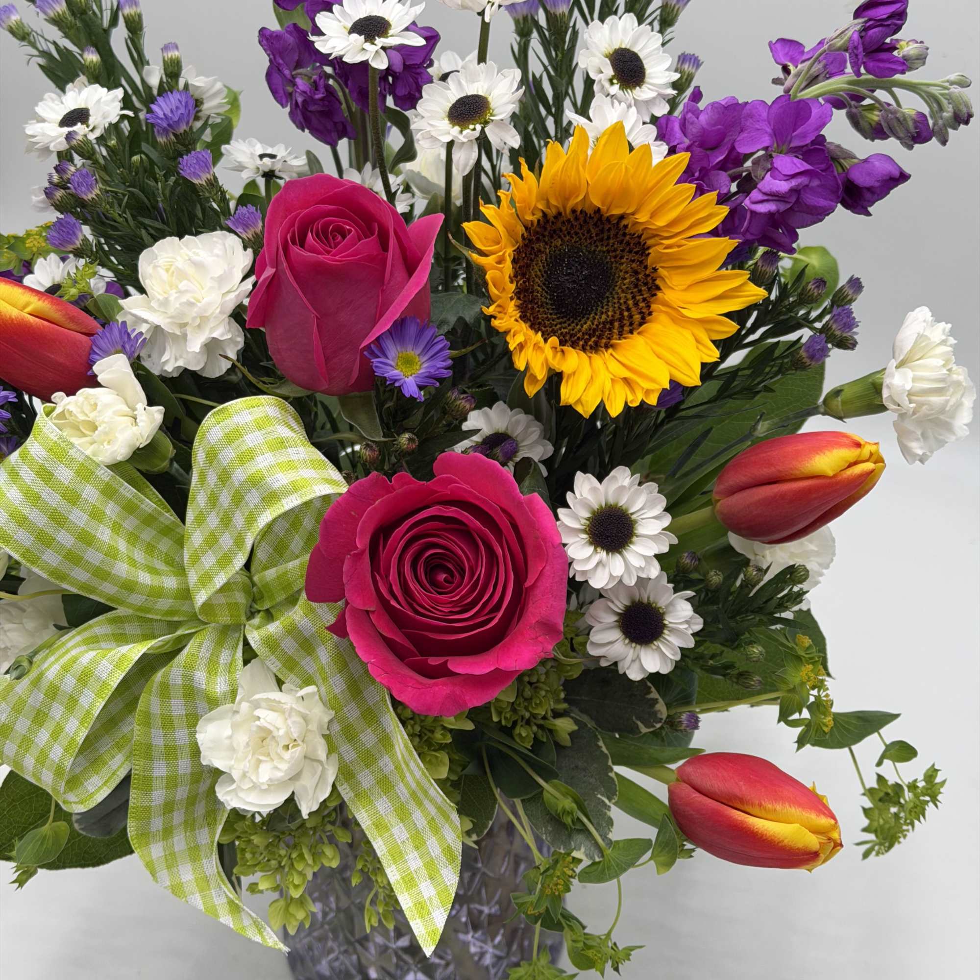 Bright &amp; Uplifting, this lively garden-style arrangement blends bold pink roses, sunny