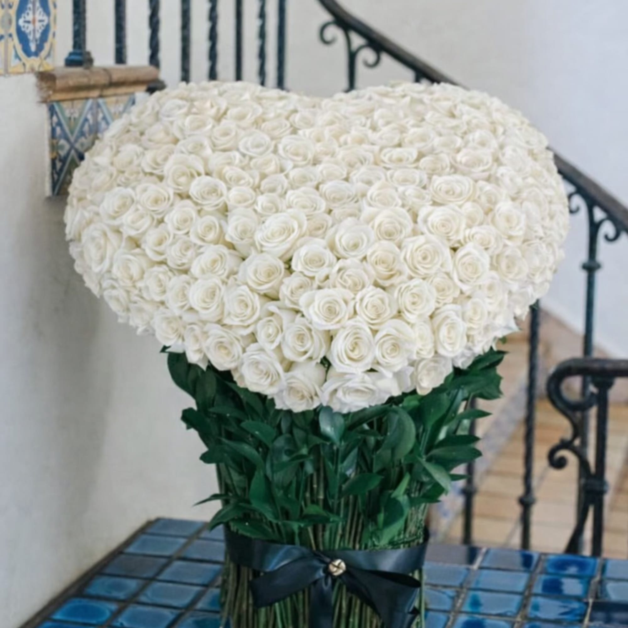 This breathtaking creation features a heart-shaped arrangement of over 250 velvety white