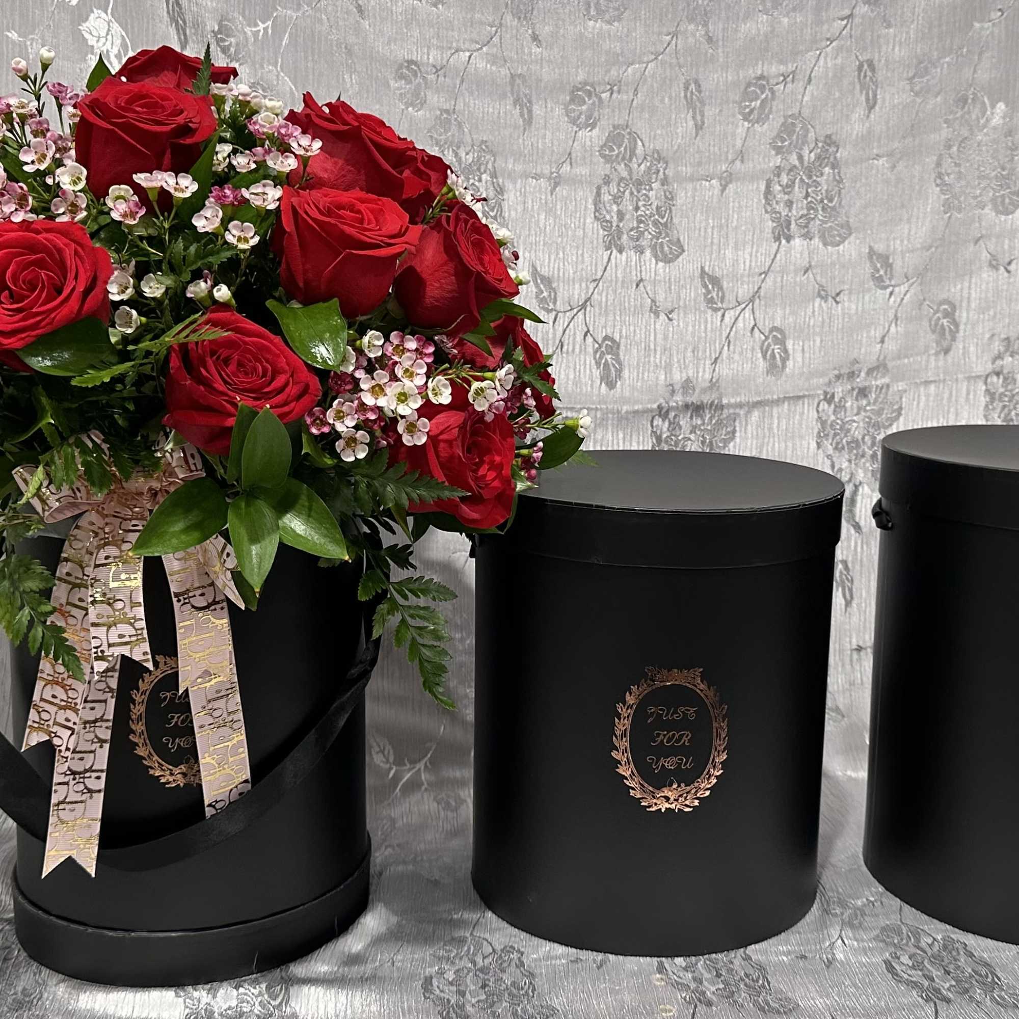 Small box wit 2 doz red roses and filler flowers. (Diamond pins