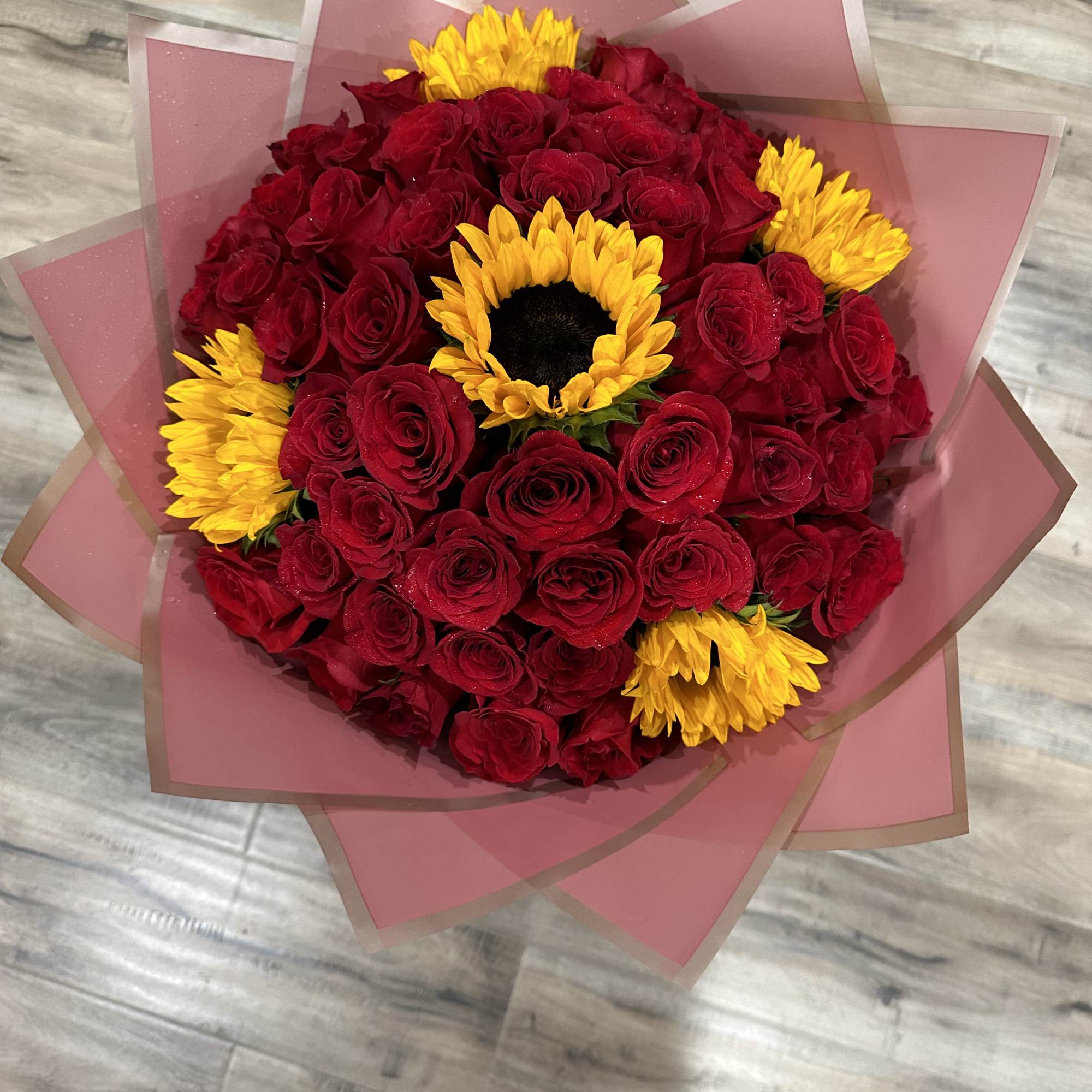 Standard:50 Red Roses and 5 Sunflower and choice of color wrapping paper
Deluxe: