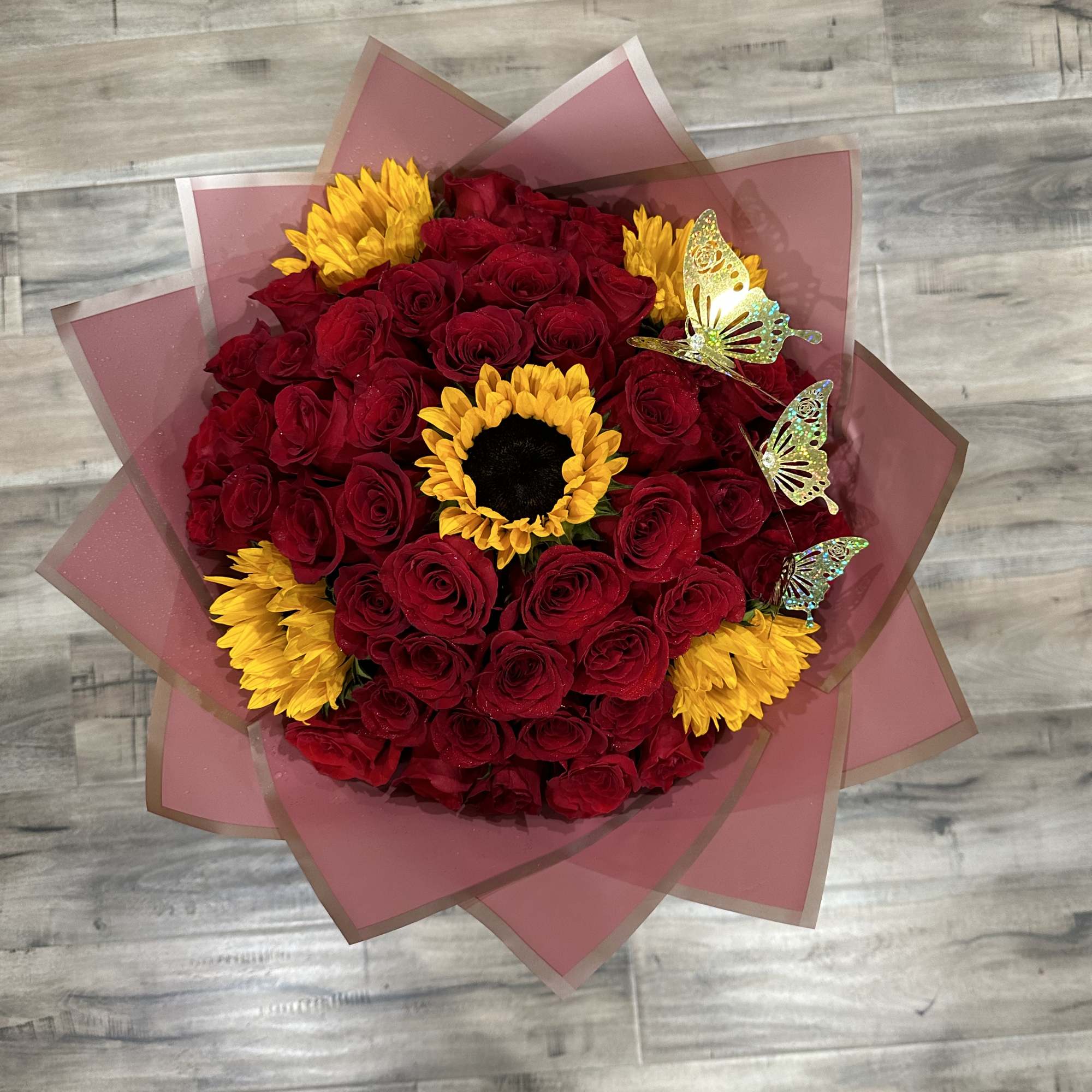 Standard:50 Red Roses and 5 Sunflower and choice of color wrapping paper
Deluxe:
