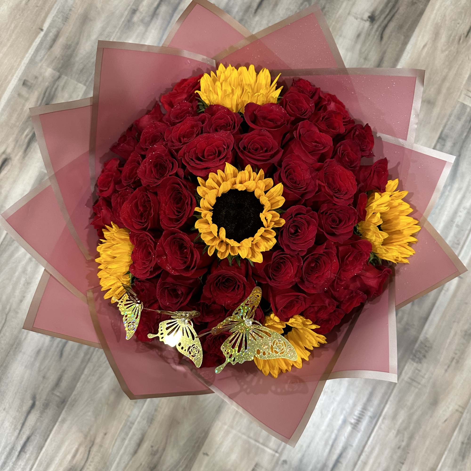 Standard:50 Red Roses and 5 Sunflower and choice of color wrapping paper
Deluxe: