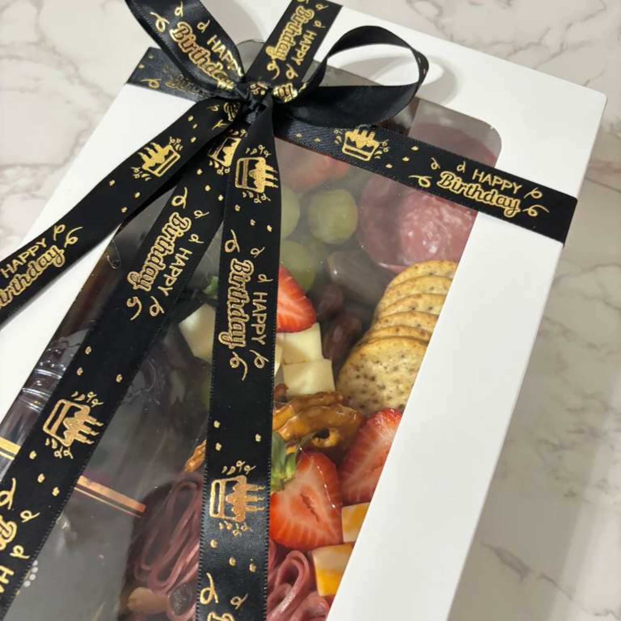 Different cheeses, meats, fruits, crackers. Stella Rose Black Bottle 