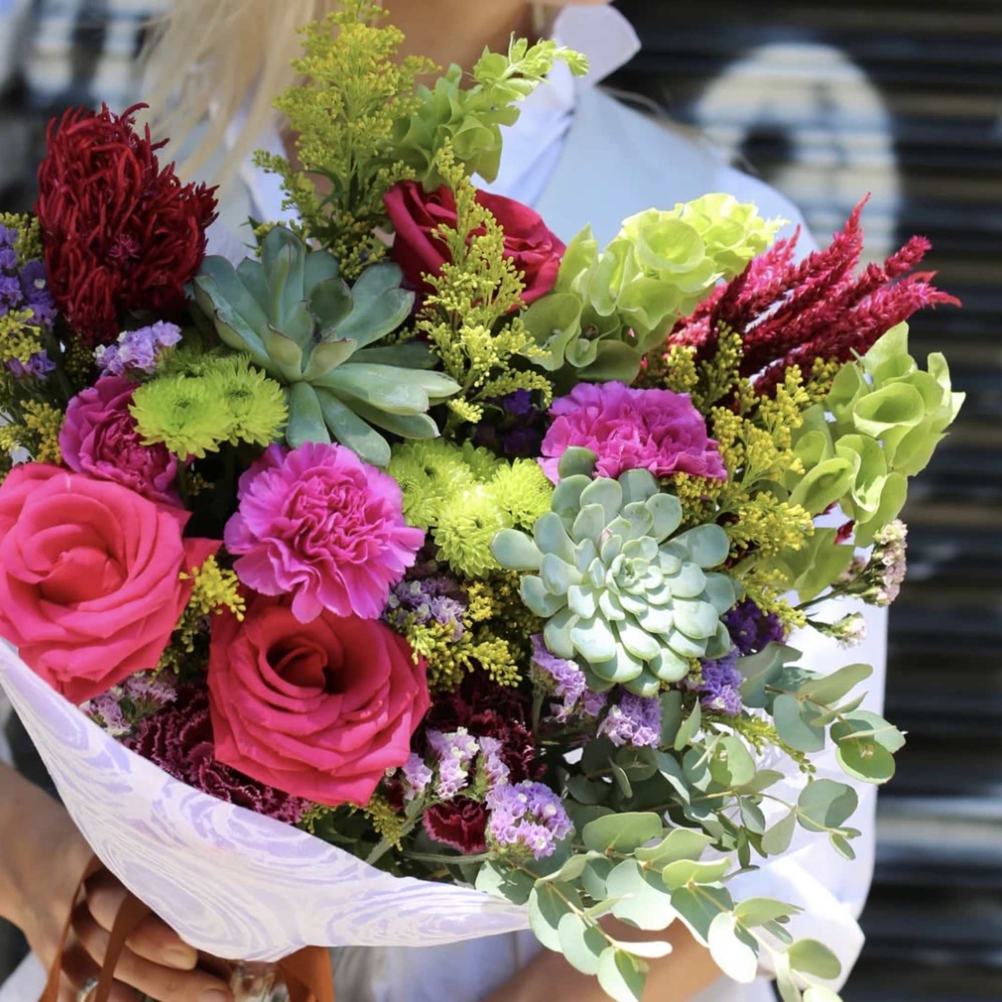 A joyful, colorful bouquet designed to brighten any day. Featuring vibrant roses