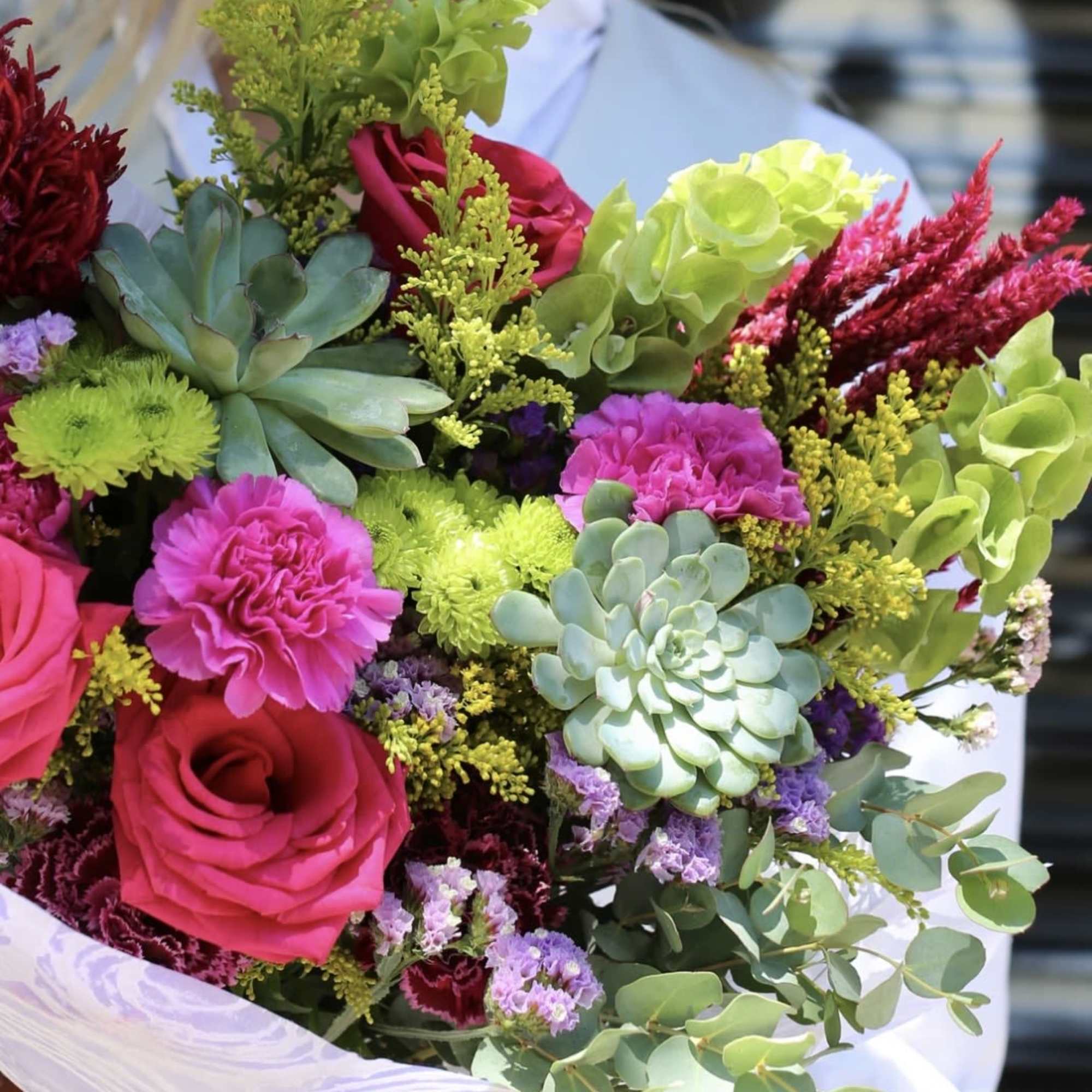 A joyful, colorful bouquet designed to brighten any day. Featuring vibrant roses