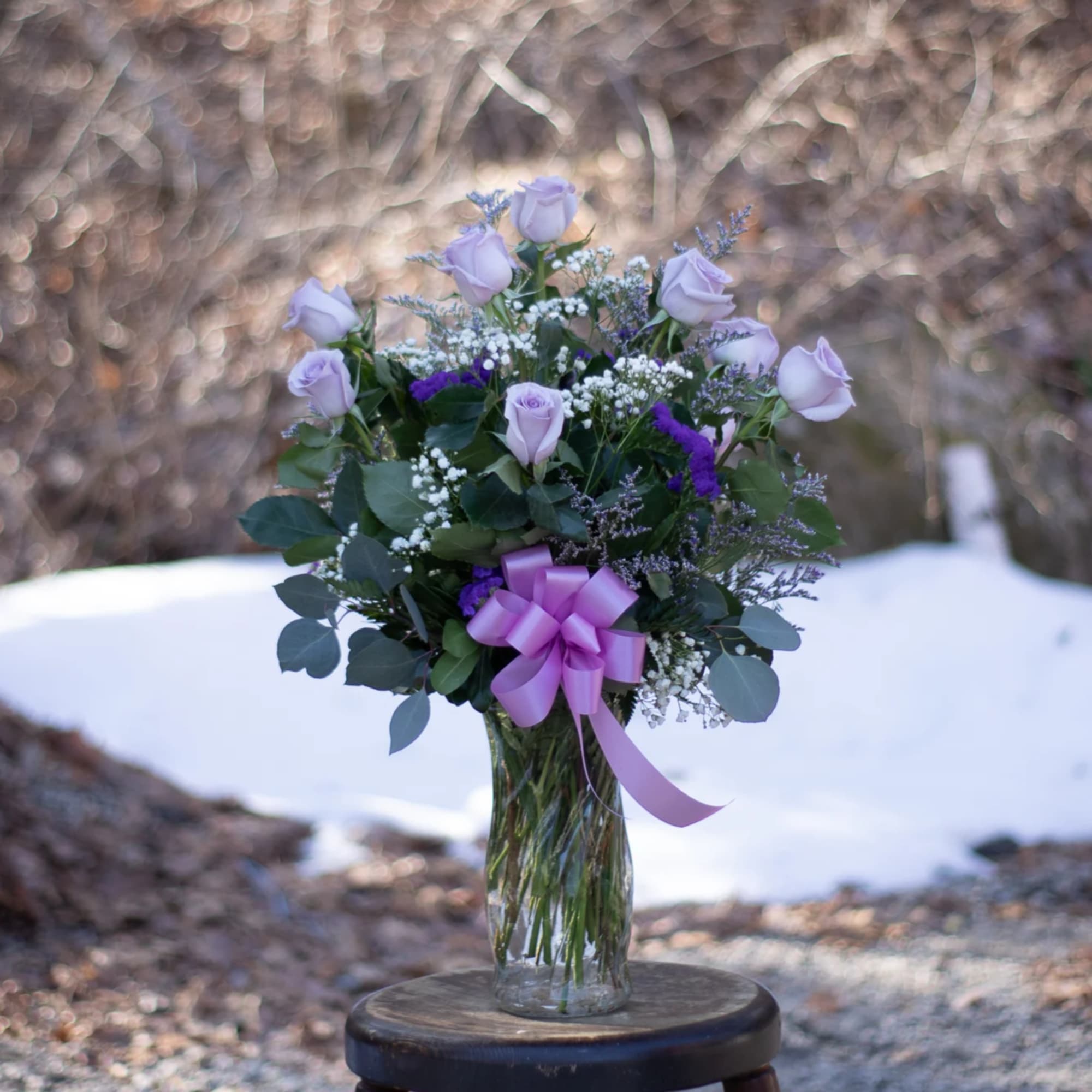 Beautiful and fragrant lavender roses arranged  in a glass vase. Extra