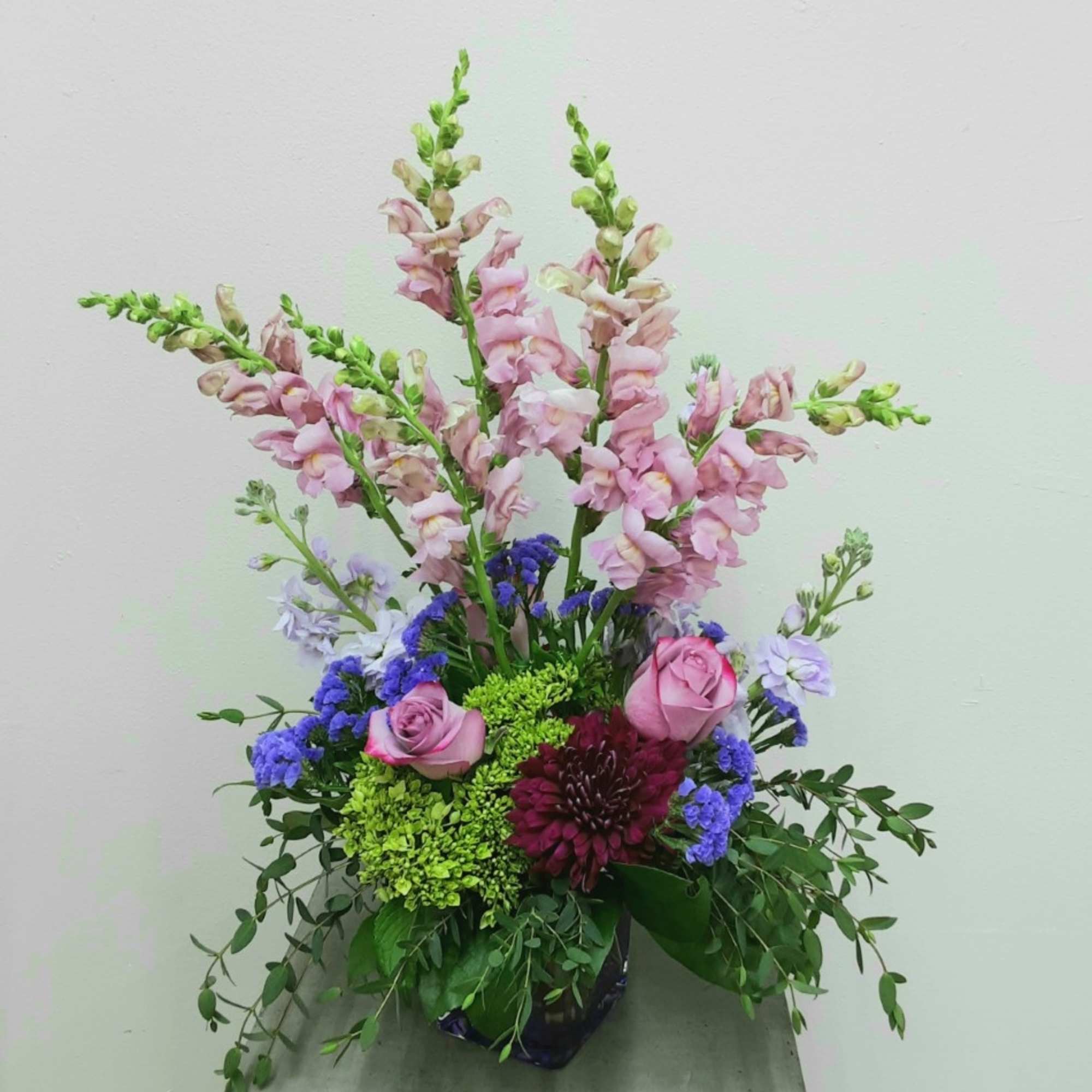 Lavender roses, purple/lav. stock, purple larkspurg, purple mum, purple statice and a