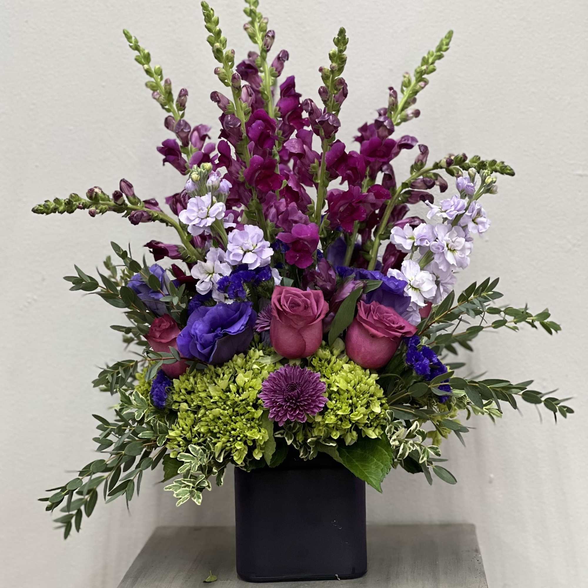 Lavender roses, purple/lav. stock, purple larkspurg, purple mum, purple statice and a