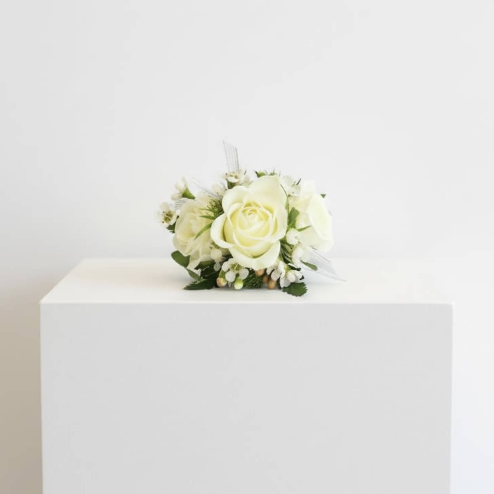 A classic white corsage hand-made that compliments any outfit. A beautiful addition