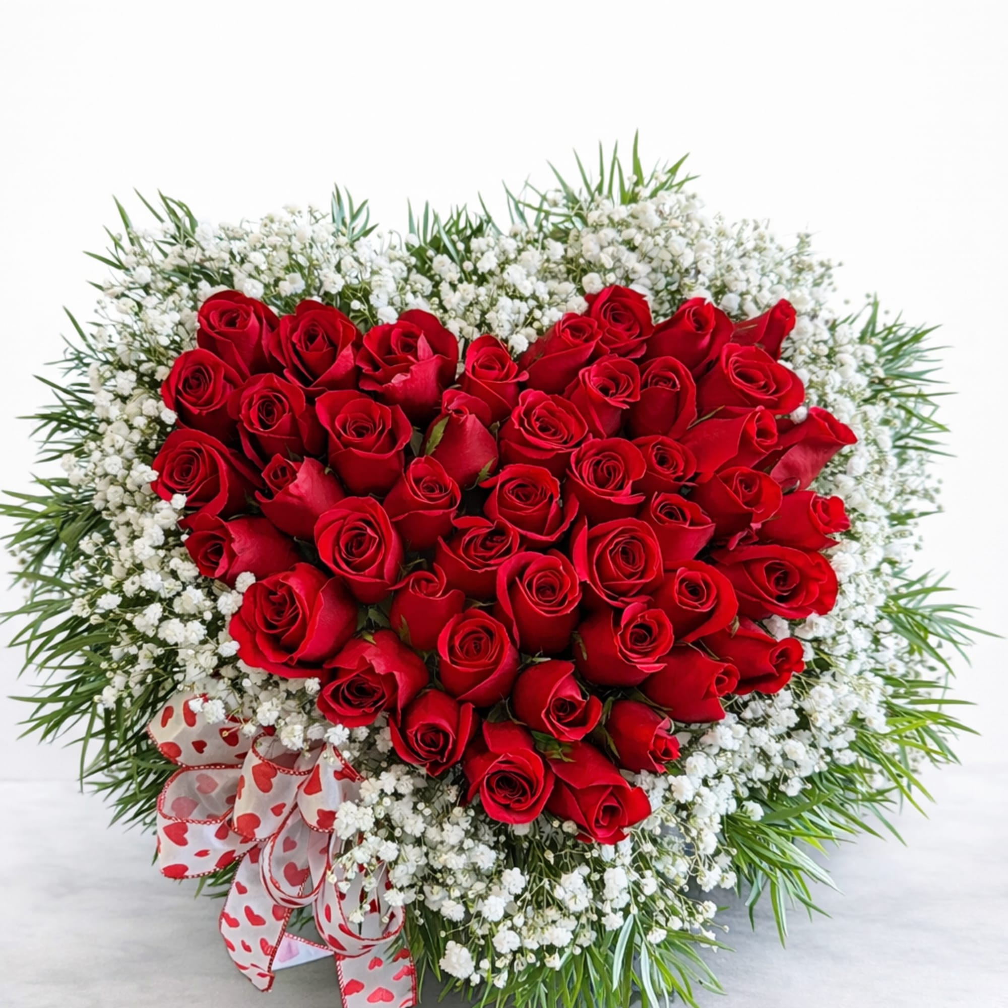 A bold and romantic heart-shaped arrangement designed exclusively by Cactus Flowers by