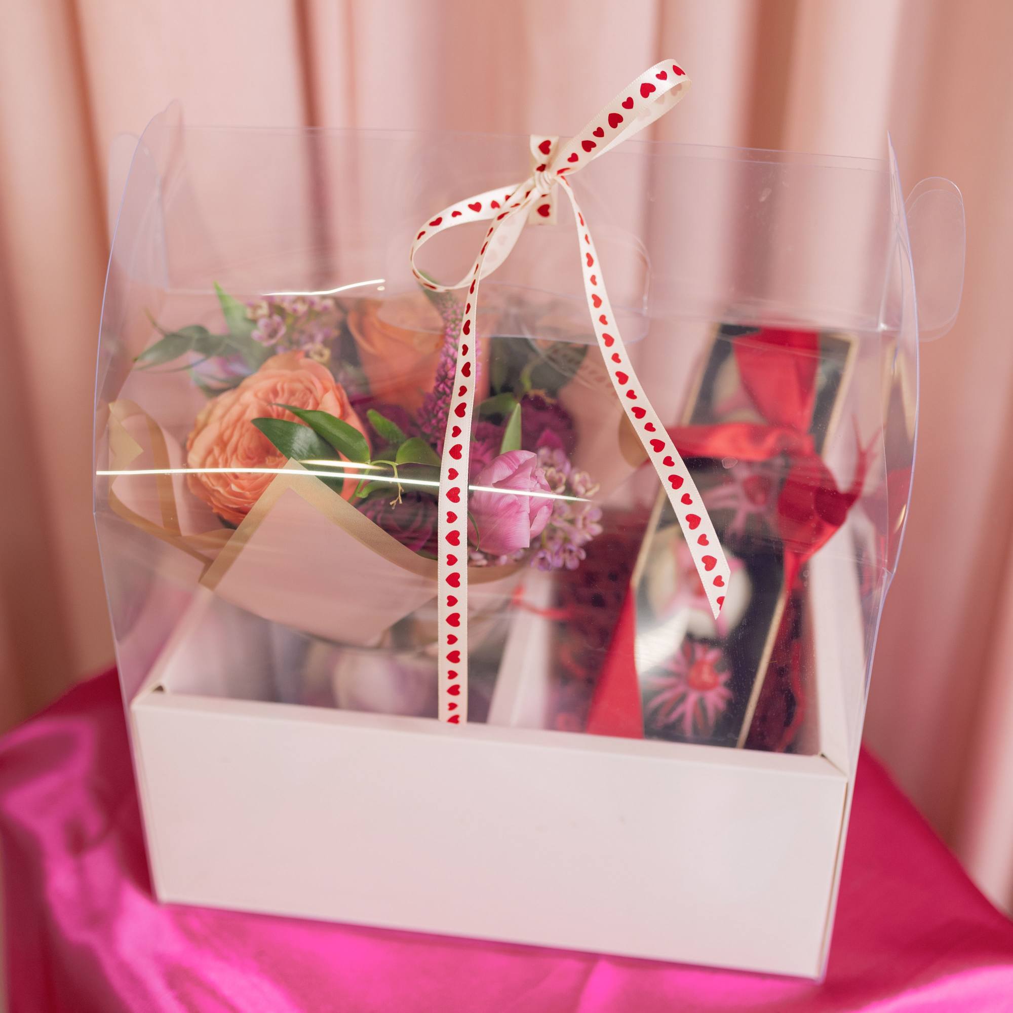 Fudge truffles with a pink and red floral arrangement arrives in a